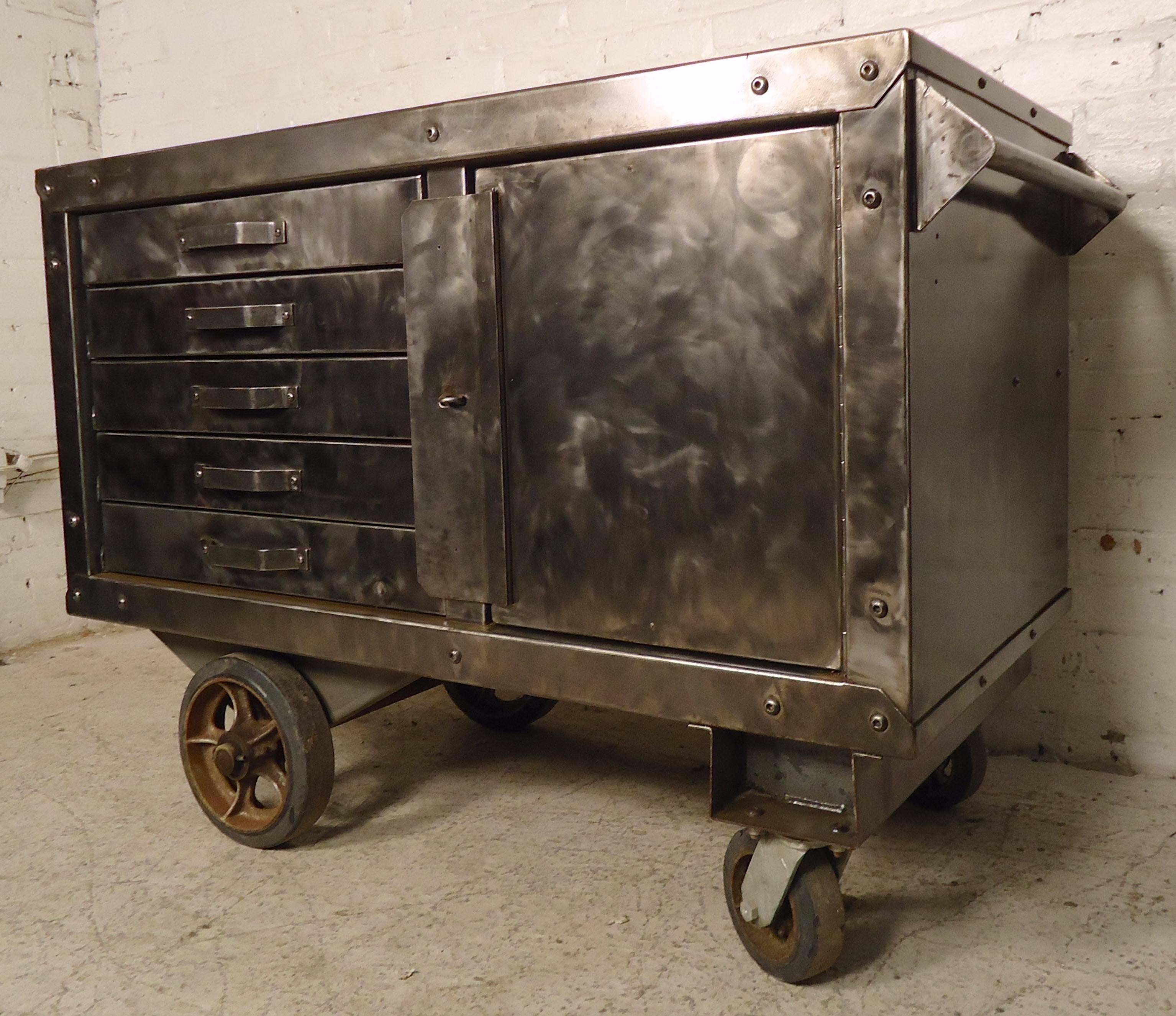 Awesome vintage metal rolling cabinet, refinished in a bare metal style. Makes for a great kitchen island or unique office storage. Five drawers, side cabinet, large casters, metal handle.

(Please confirm item location - NY or NJ - with