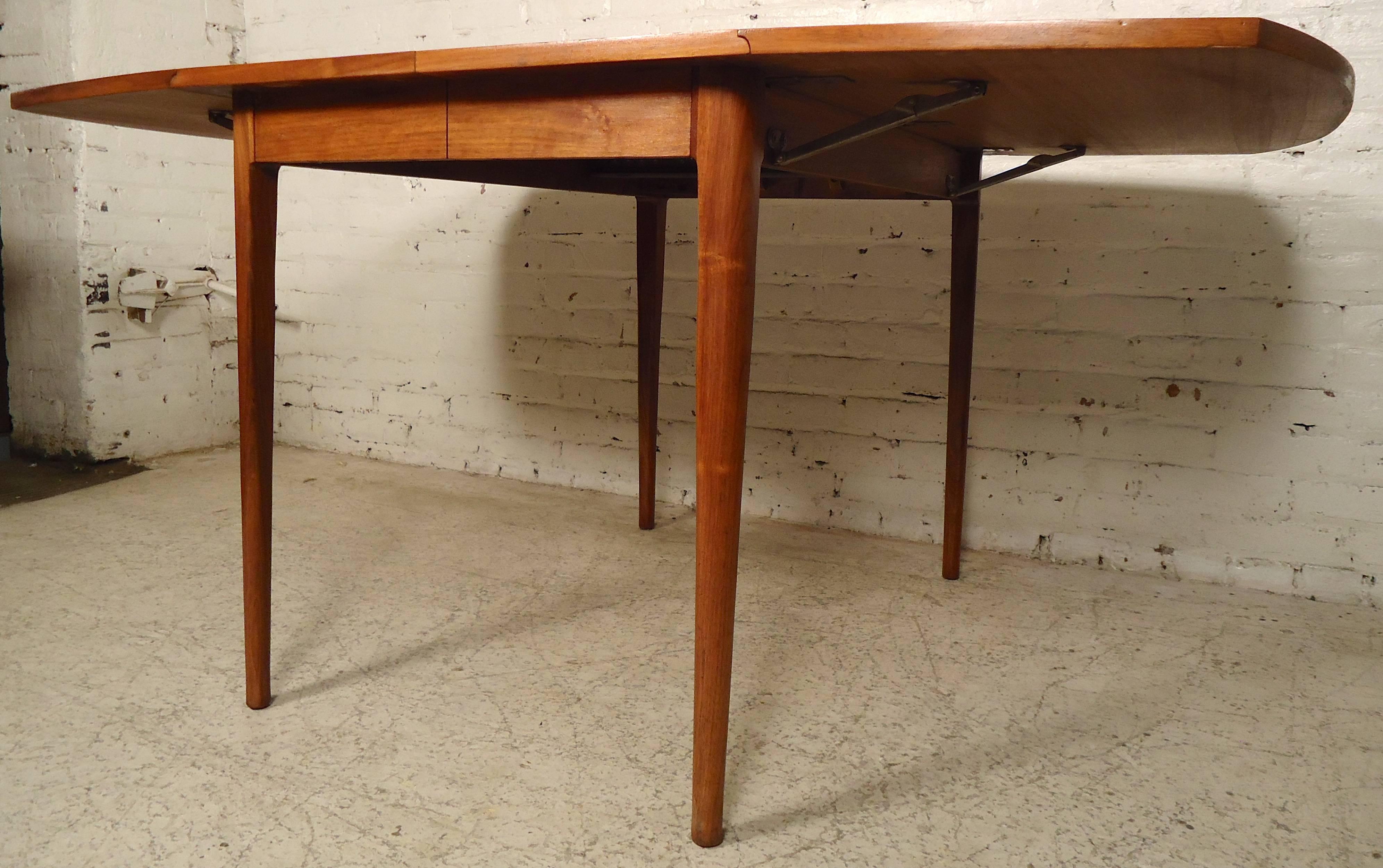 Refinished vintage dining table designed by Kipp Stewart for Drexel features warm walnut grain throughout, rounded drop leaves, and space for additional leaves.
Open: 62