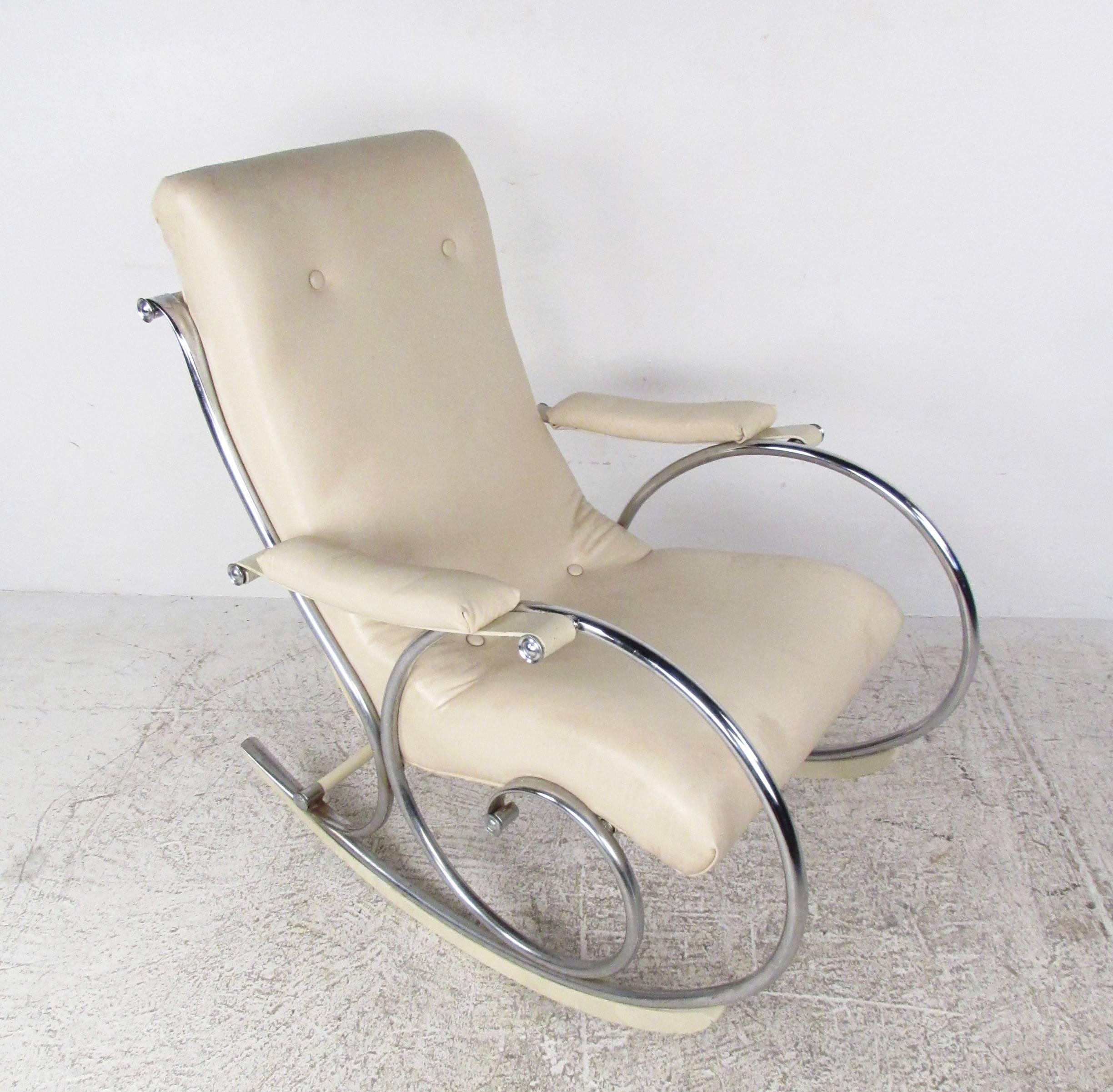 This sleek modern rocking chair features a tufted vinyl seat with stylish chrome frame. Mounted wooden rockers ensure a fluid rocking motion, while padded armrests and high back seat ensure optimal comfort. This beautiful Mid-Century Modern rocking