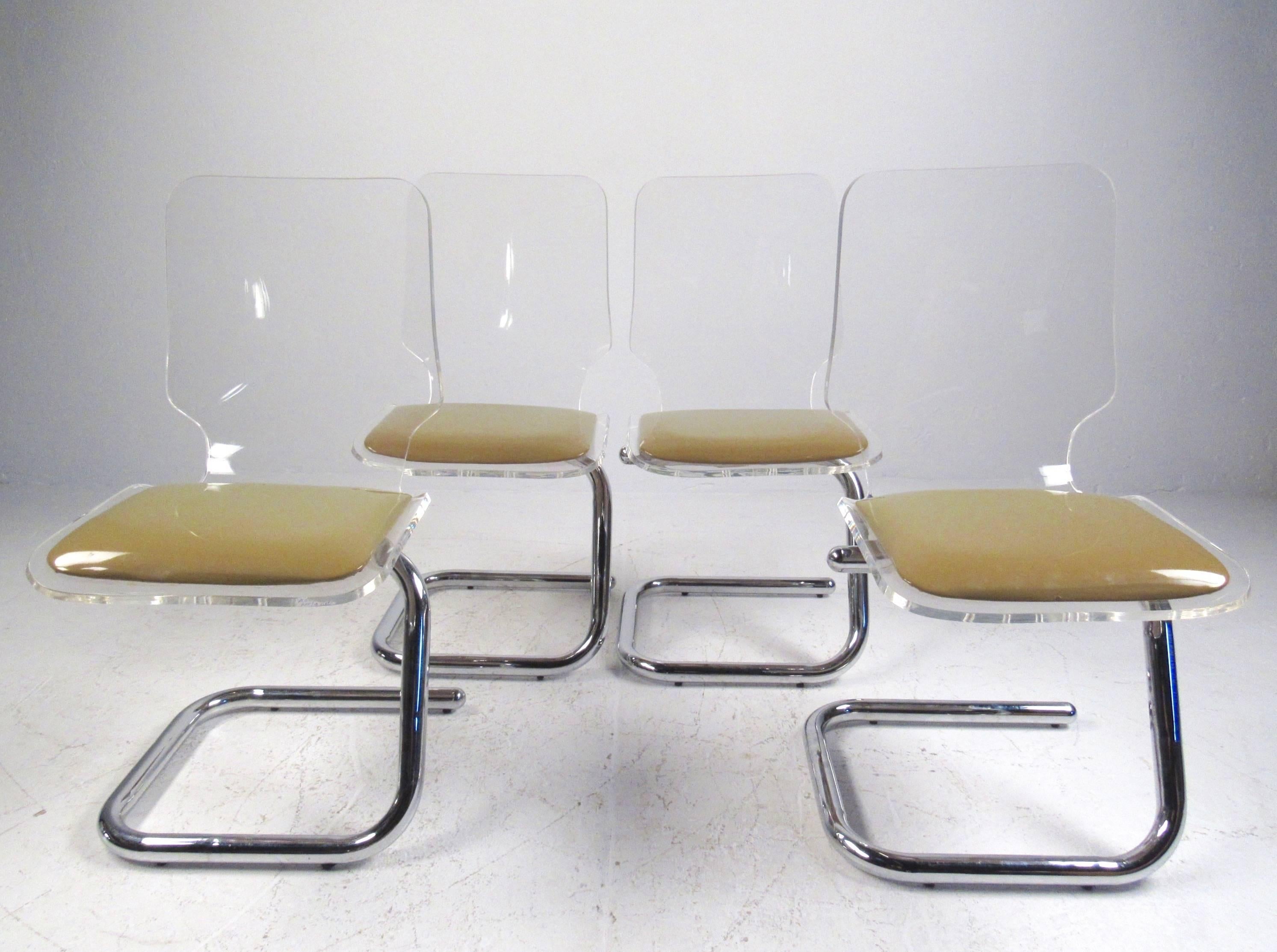 This impressive set of four Mid-Century Modern Lucite and chrome dining chairs features stylish cantilever design with sculpted backs and padded seats. Comfortable and stylish set of chairs by Luigi Bardini for Miniforms and Hill Manufacturing.