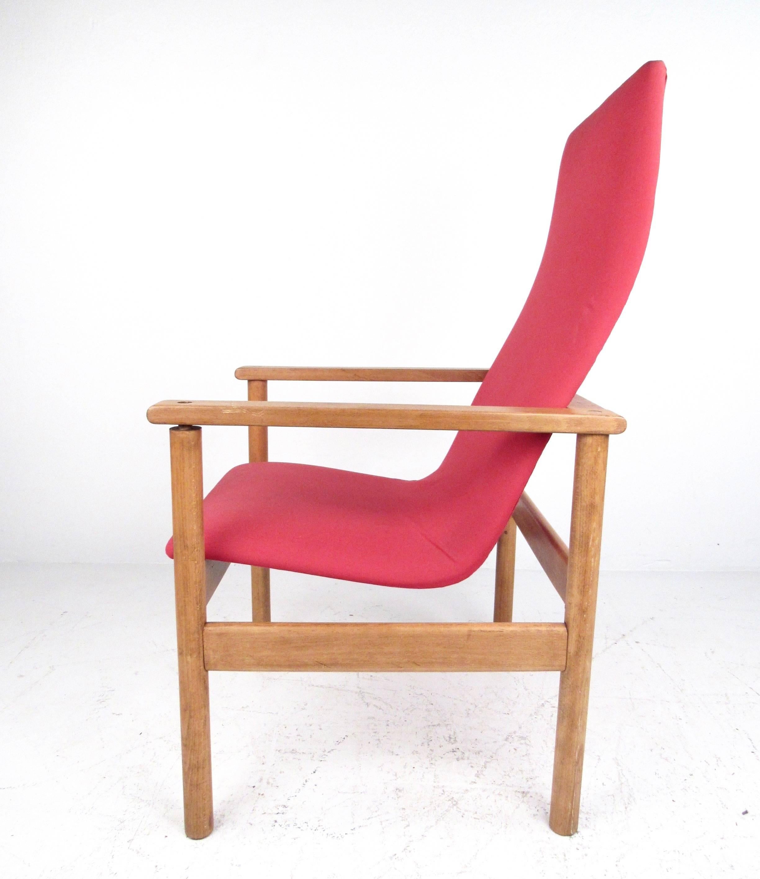 This stylish Mid-Century armchair features a vintage hardwood frame with ergonomic sculpted high back seat. Modern simplicity meets timeless style in this vintage lounge chair perfect for home or business use. Please confirm item location (NY or NJ).