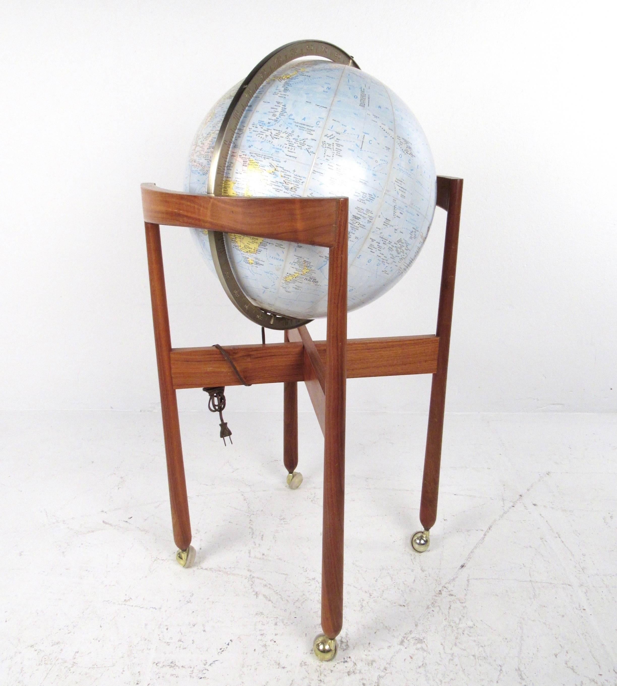 This beautiful vintage globe turns on its axis as mounted on a vintage teak stand. Complete with casters and interior illumination this vintage Replogle comprehensive globe features a vintage world map. Please confirm item location (NY or NJ).