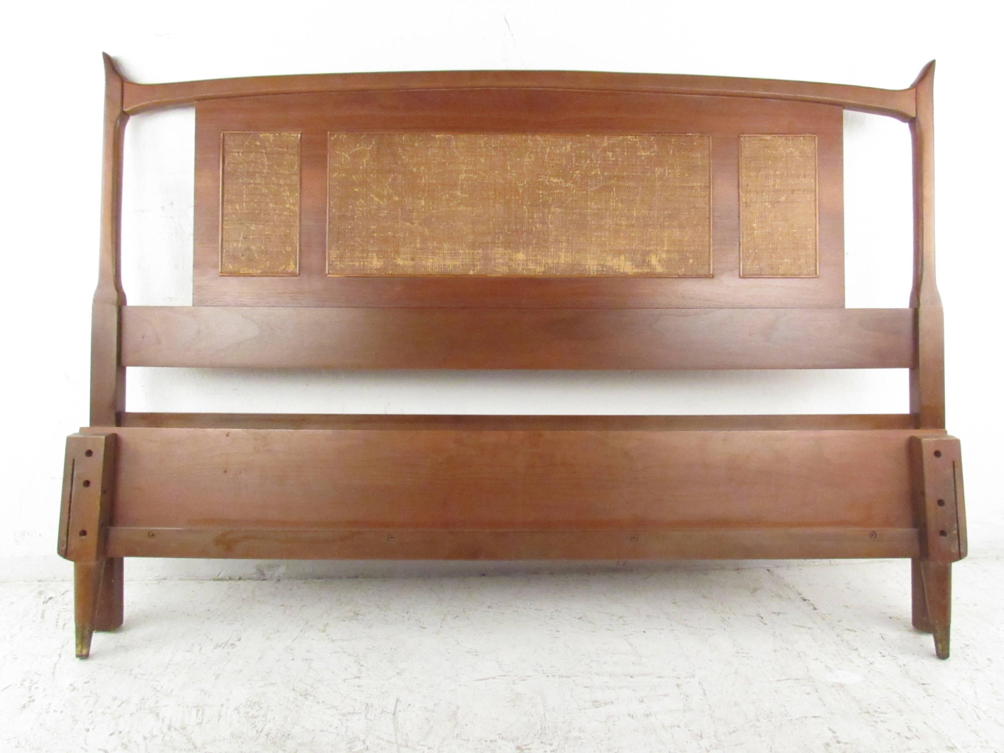 This unique vintage walnut full size headboard features a unique sculpted shape with cane front details. Includes matching foot board. Please confirm item location (NY or NJ).