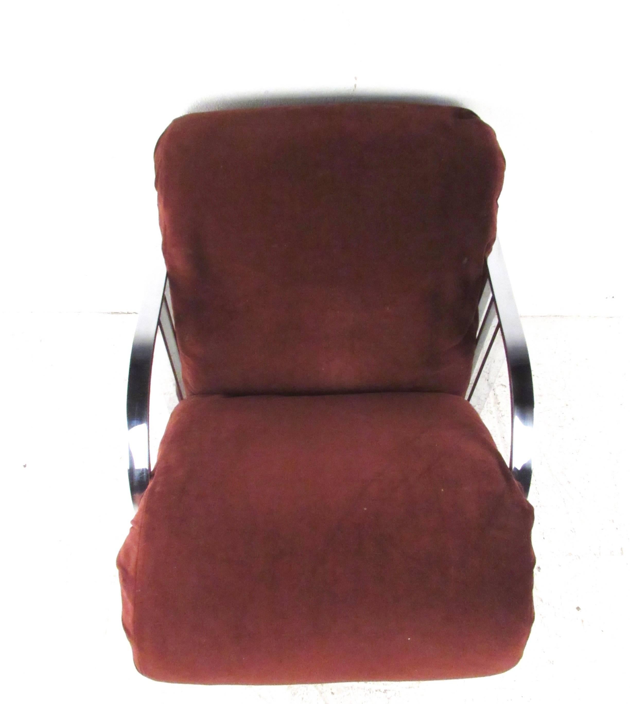 This unique low profile lounge chair features stylish Mid-Century chrome and a plush upholstered seat. The vintage modern mix of design and comfort seems to have been inspired by Mid-Century master Milo Baughman. Please confirm item location (NY or