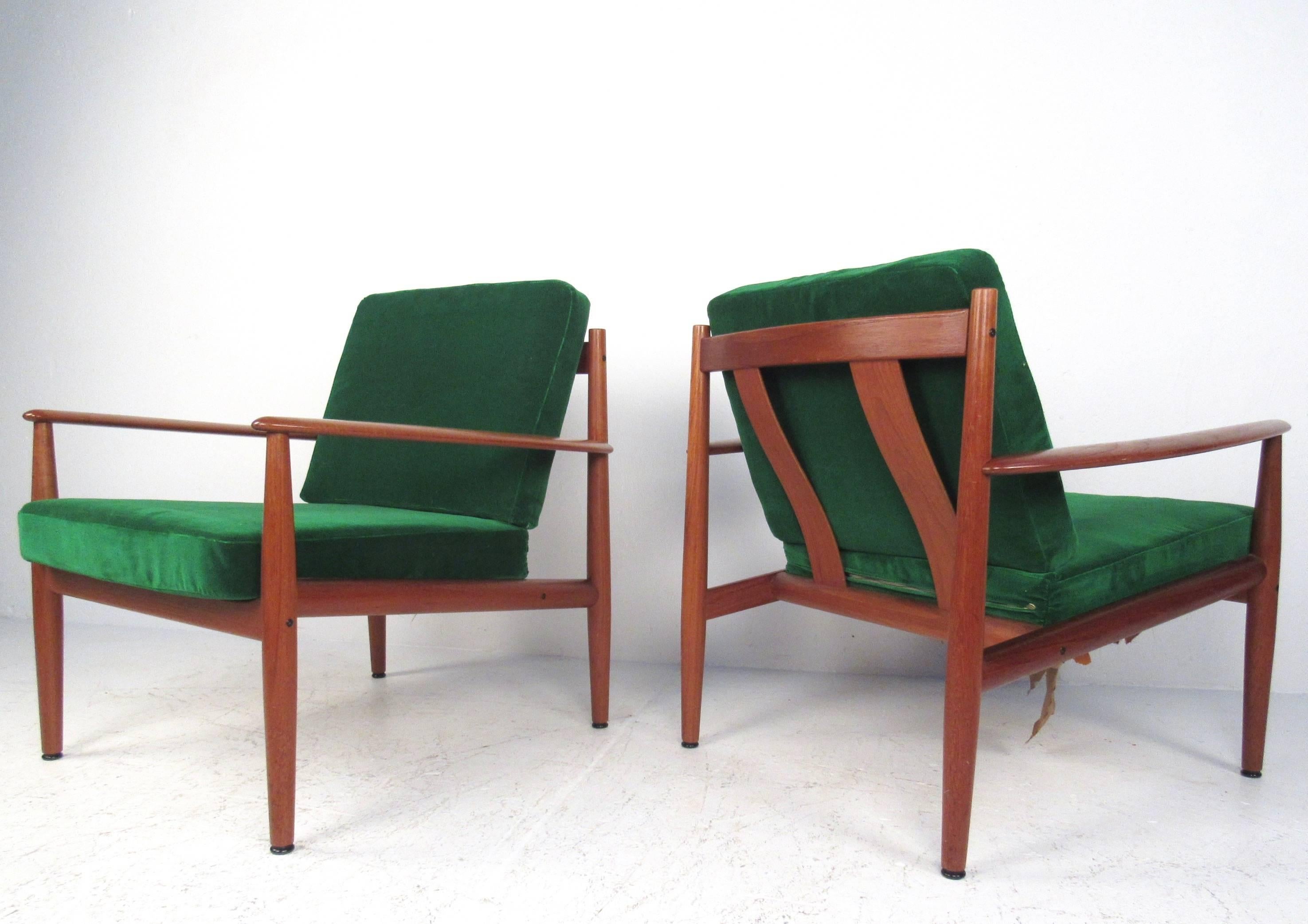This vintage pair of teak armchairs features unique sculpted frames designed by Grete Jalk for France and Son. Plush green microsuede/velour-like upholstery over spring style seats make this pair of the perfect mix of comfort and style. Original