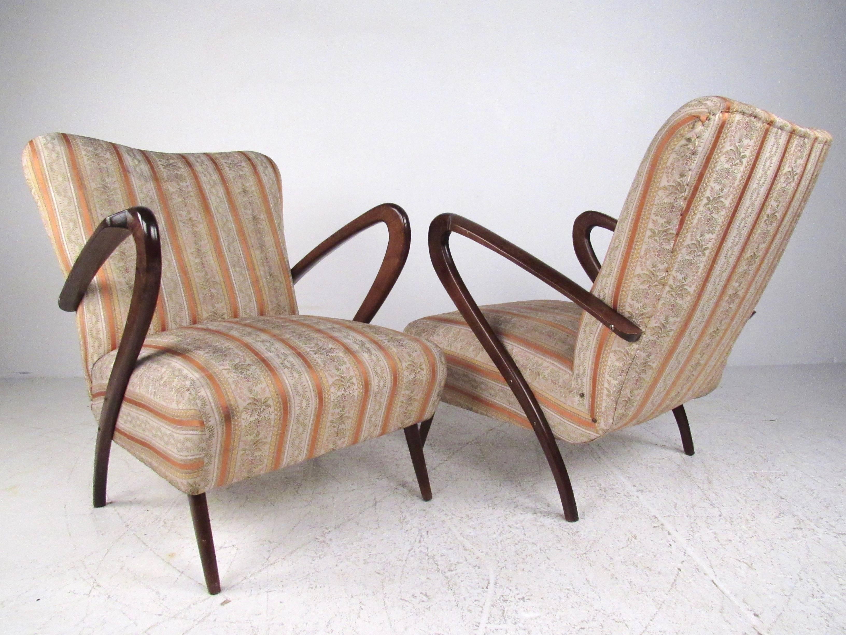 This beautiful pair of Mid-Century Italian lounge chairs features stunning sculpted armrests, with a lovely patinated finish. Floral motif patterned fabric adds to the vintage appeal of the pair. Matching settee also available, please confirm item