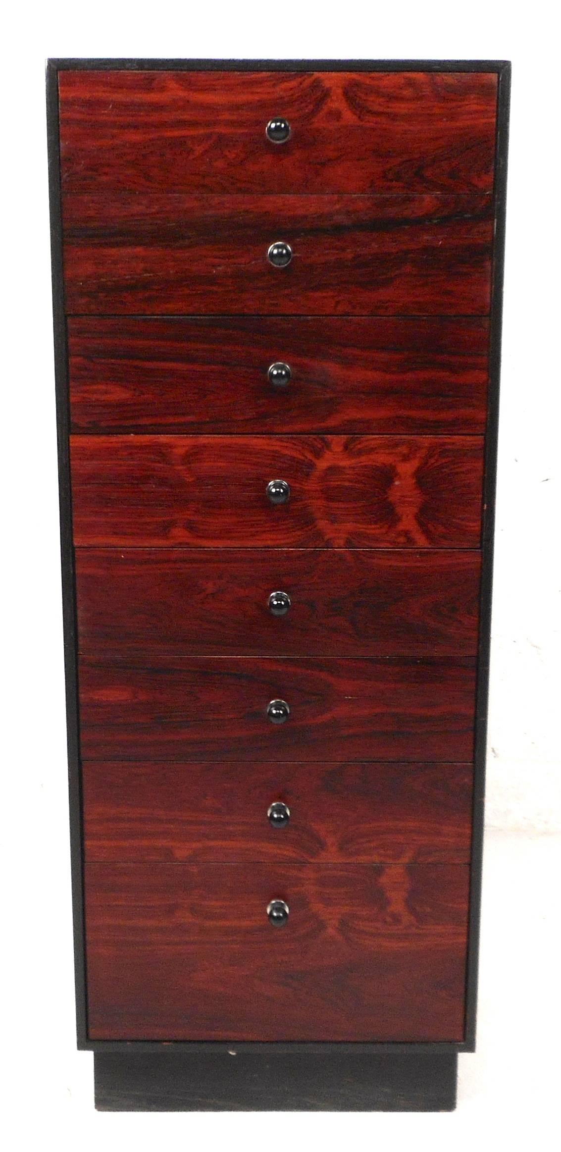 Stunning vintage modern jewelry cabinet features eight drawers with unique ebonized pulls. Sleek design with rosewood fronts on each drawer and an ebonized wood case. Quality craftsmanship with dovetail joints on each drawer making it the perfect