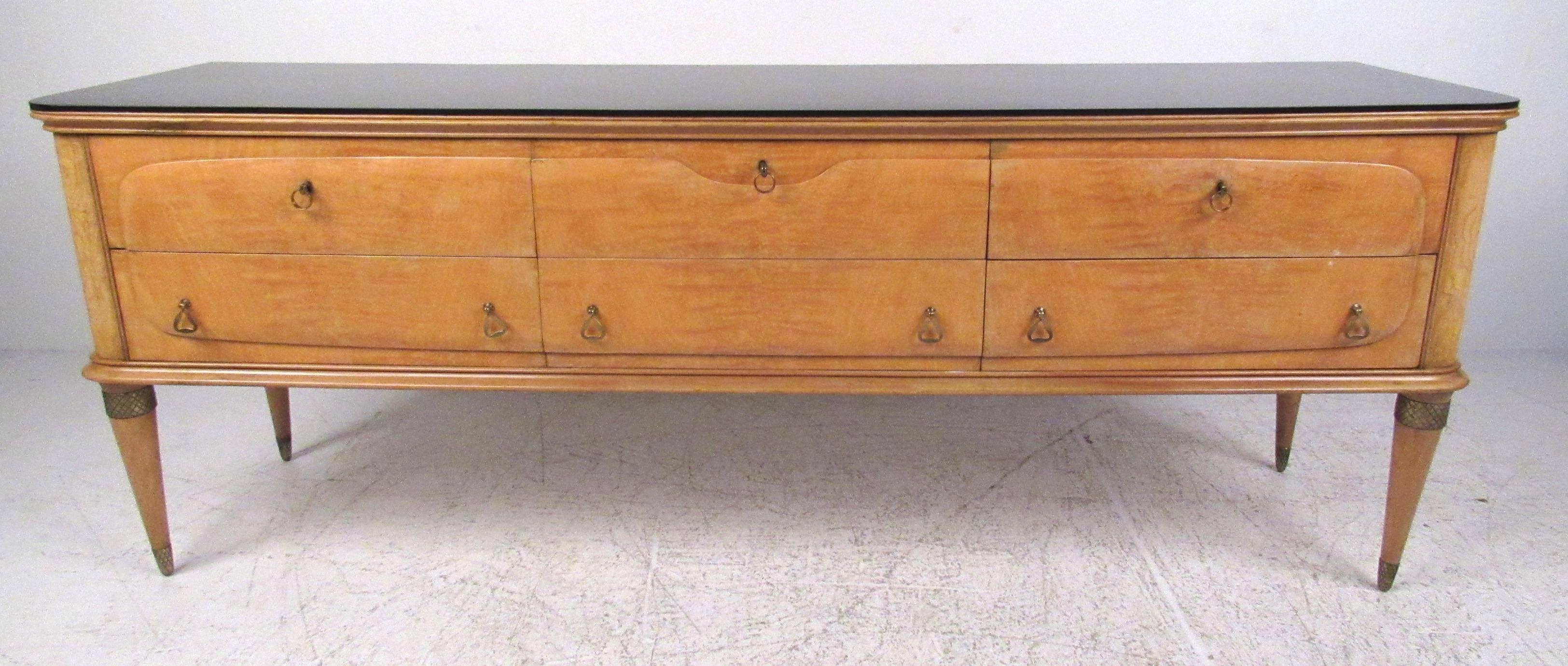 This Mid-Century Modern Gio Ponti style dresser features elegant Italian design details and six spacious drawers offering ample storage in any setting. The removable laminate style top makes a durable tabletop for dressing or storage while stylish