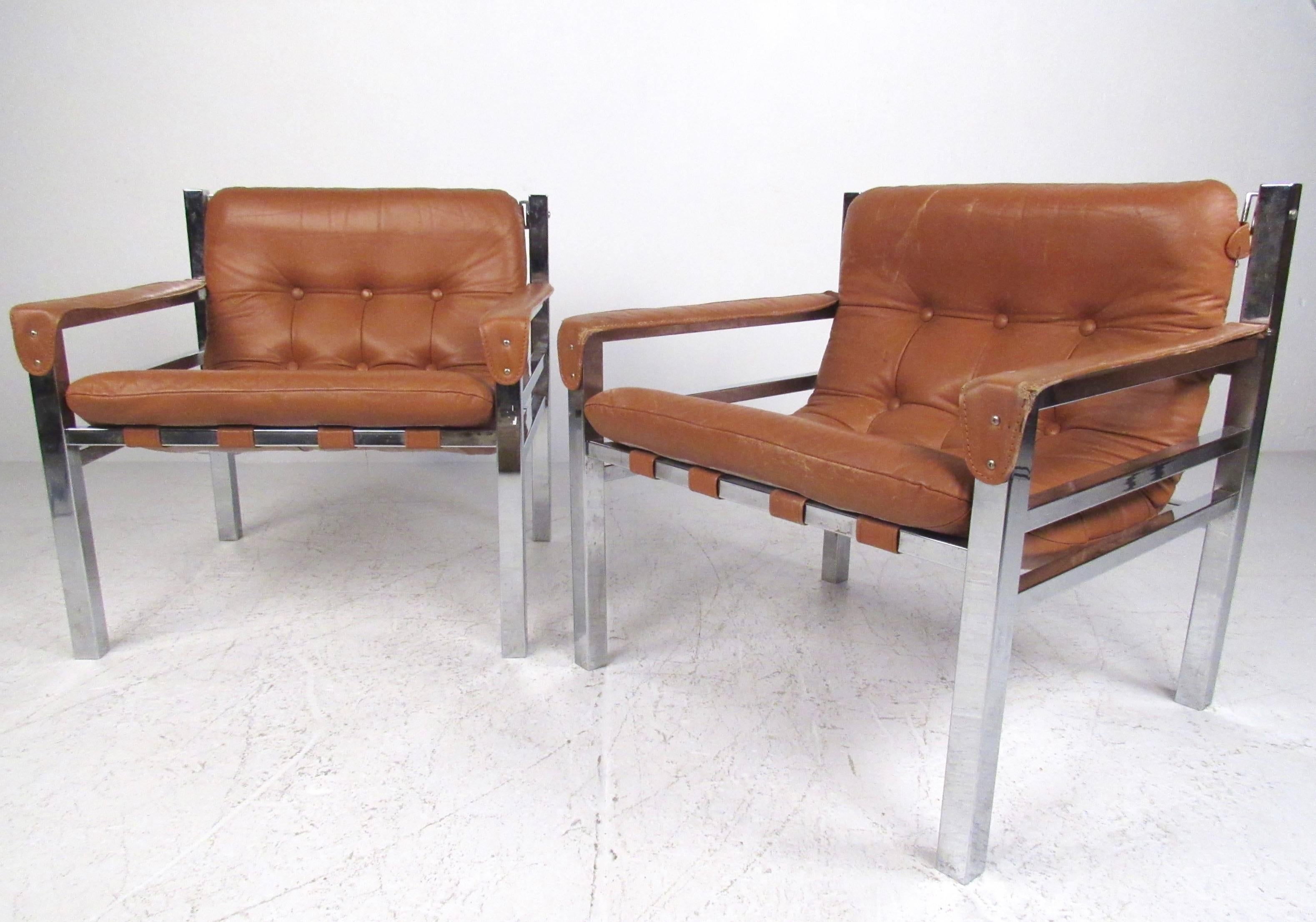 This stylish pair of Mid-Century armchairs feature tufted leather sling seats set in chrome frames. Unique vintage style is evident in this pair of comfortable 1970s lounge chairs. Please confirm item location (NY or NJ).