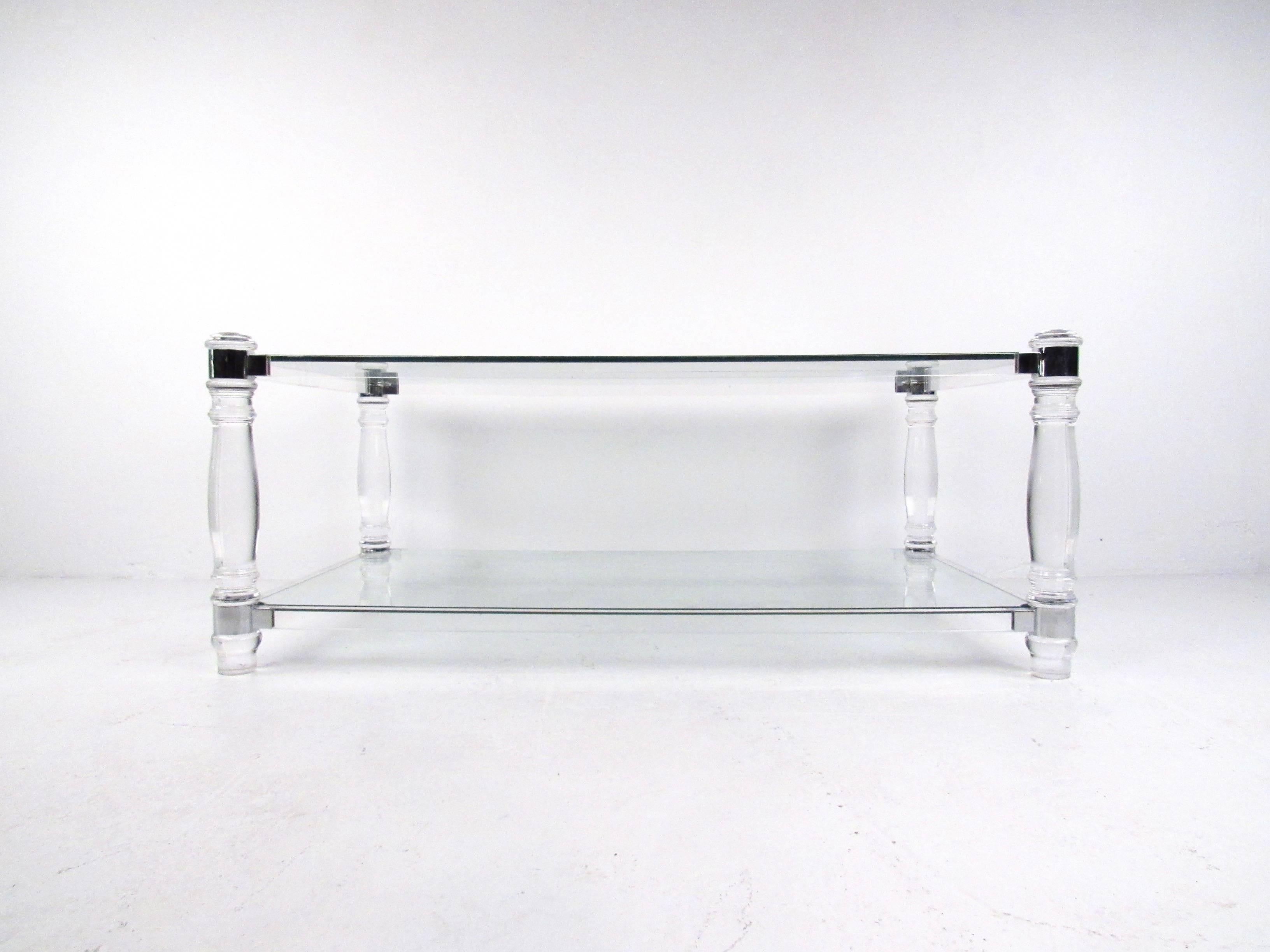 This stunning sculpted Lucite coffee table features ornately turned Lucite posts with complimentary chrome trim. The two tier design of this Charles Hollis Jones style coffee table makes this an impressive modern addition to any interior. Please