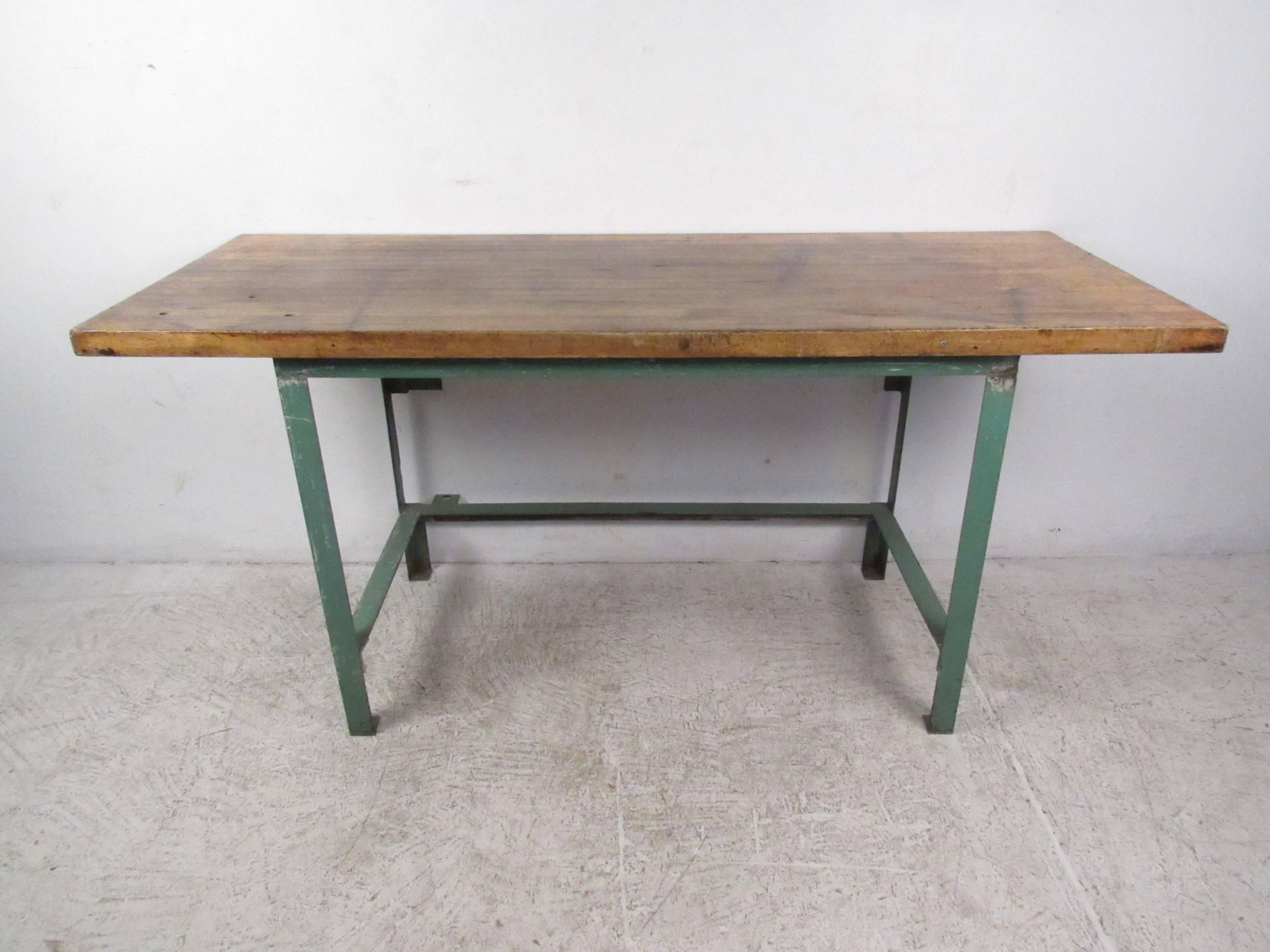 This tall workshop bench makes an ideal work station for any vintage industrial setting. Heavy metal construction with a thick wooden top, this vintage machine table shows signs of age and use related distress. Great piece for workbench or desk,