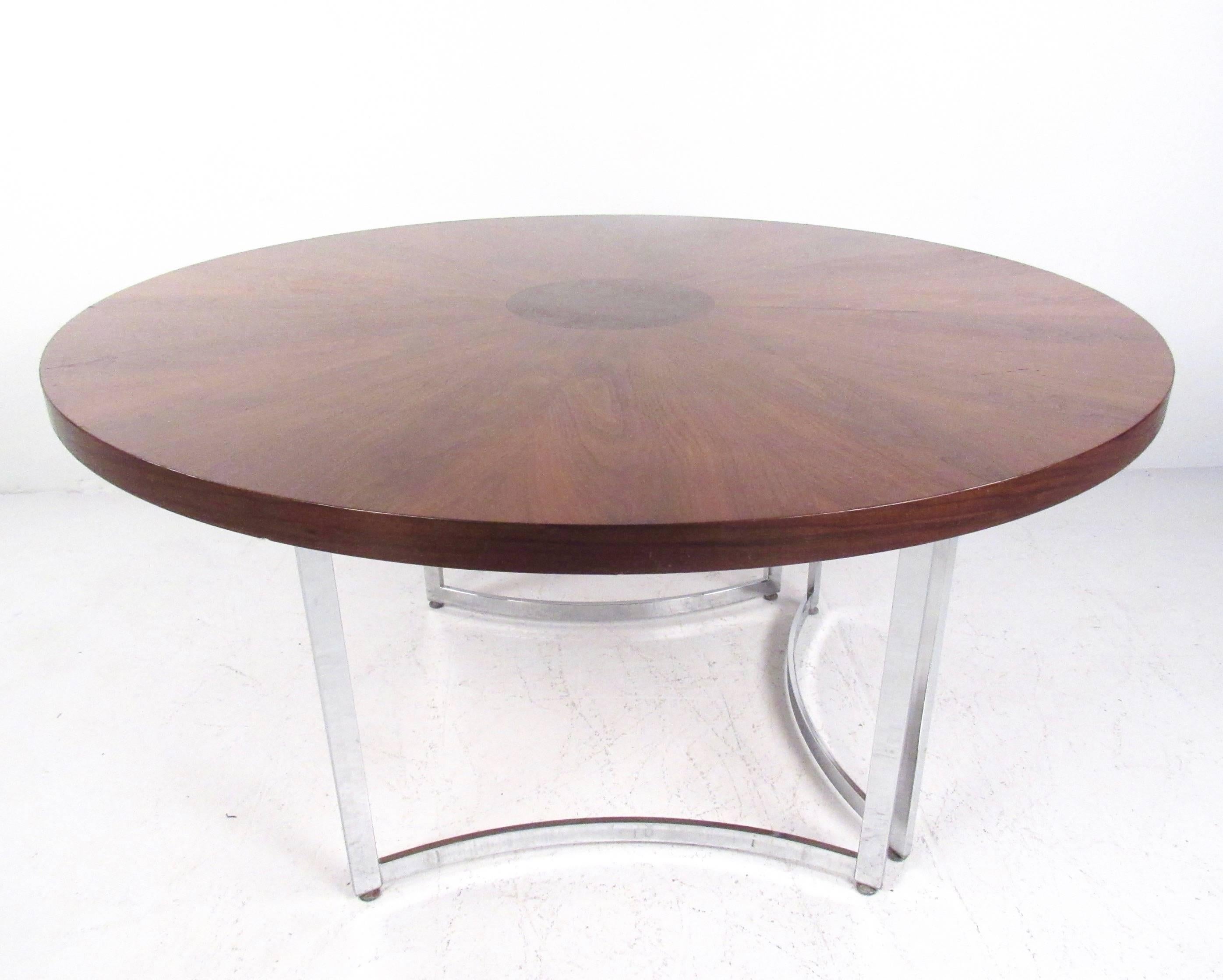 This vintage circular dining table features a beautiful burl wood marquetry top with a stylish sculpted chrome base. The sturdy Mid-Century centre table makes a lovely addition to dining room or kitchen, and offers a spacious round tabletop for