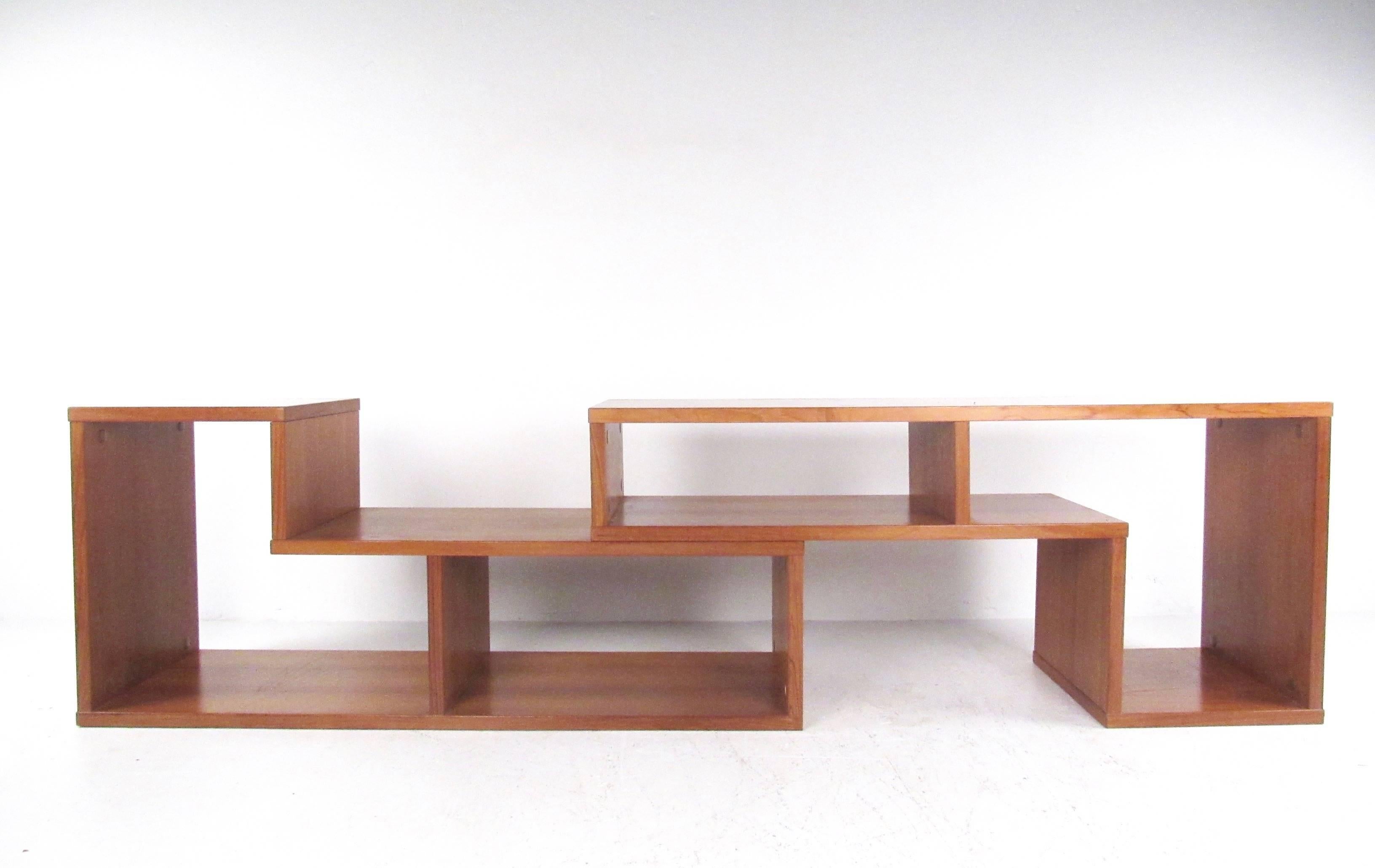 This matching pair of vintage teak bookshelves stack together to form a unique storage or display space for any home or office. Perfect for use as a TV console, bookshelf or general storage. Please confirm item location (NY or NJ).