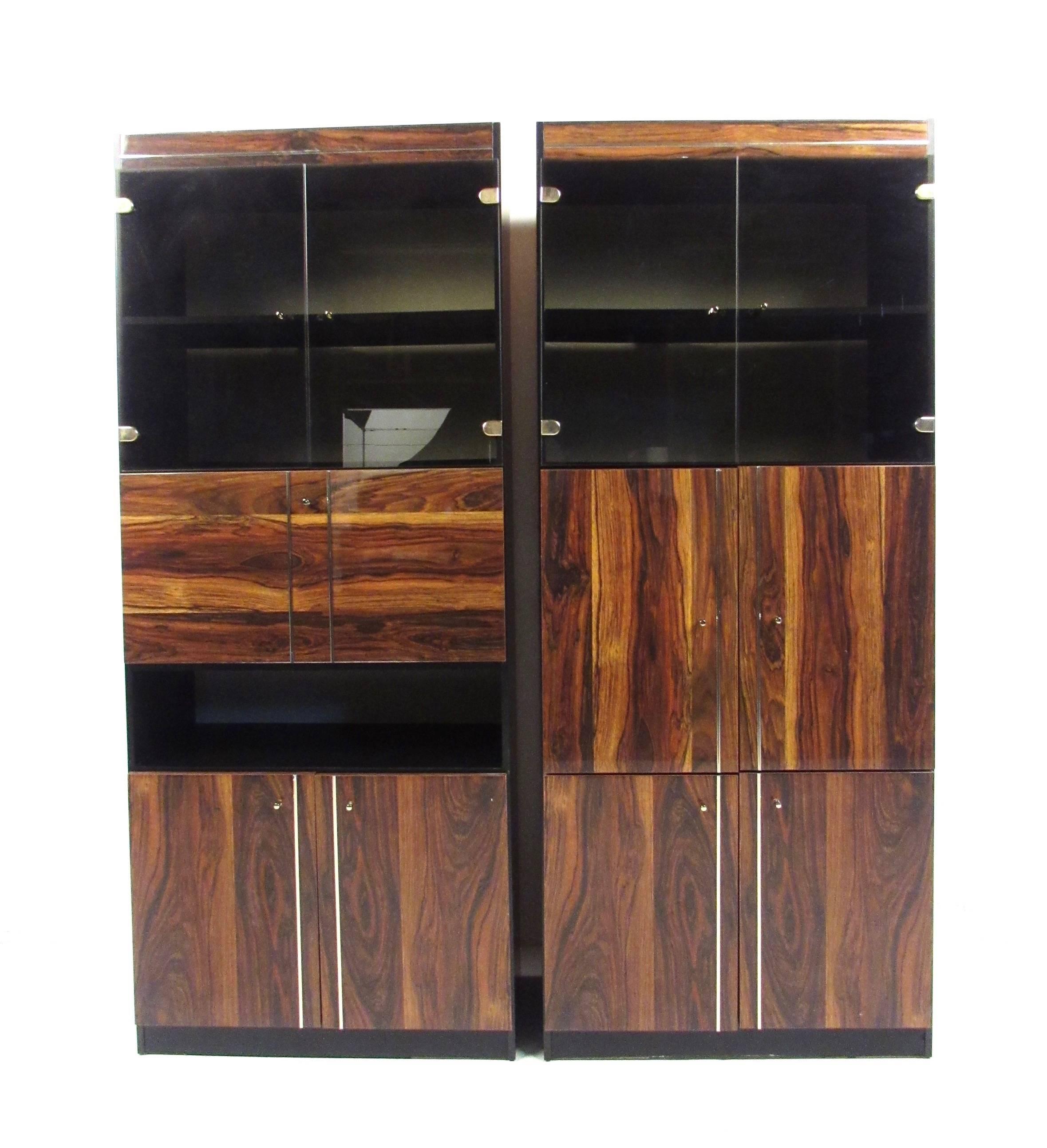 This beautiful pair of contemporary modern cabinets offer a spacious mix of display shelving and interior storage. Matching pair features rosewood style laminate fronts and unique trim, please confirm item location (NY or NJ).