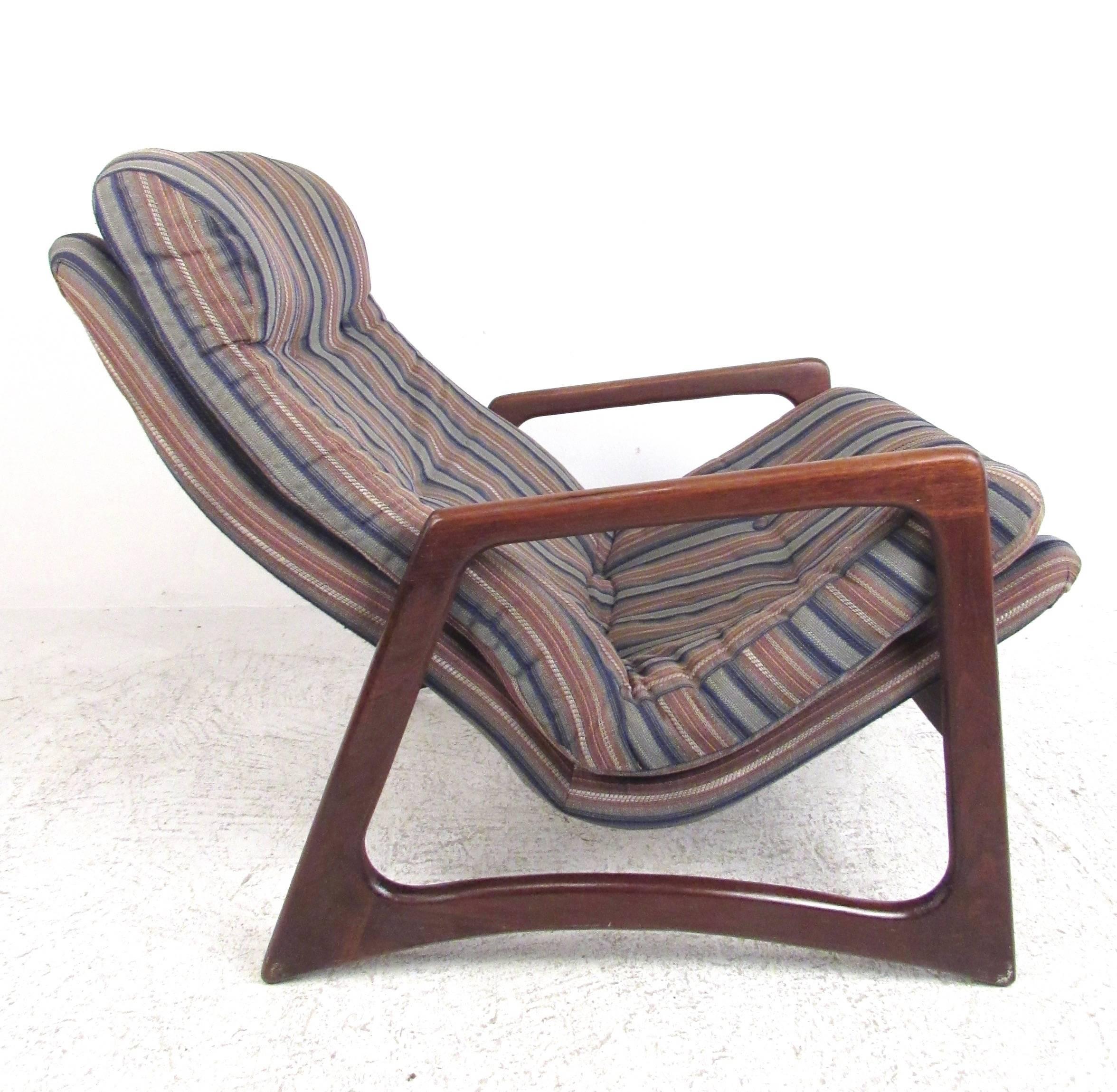 This vintage walnut lounge chair features a tufted high back lounge chair with uniquely sculpted frame. This Adrian Pearsall style chair makes a comfortable and stylish Mid-Century addition to any setting. Please confirm item location (NY or NJ).
