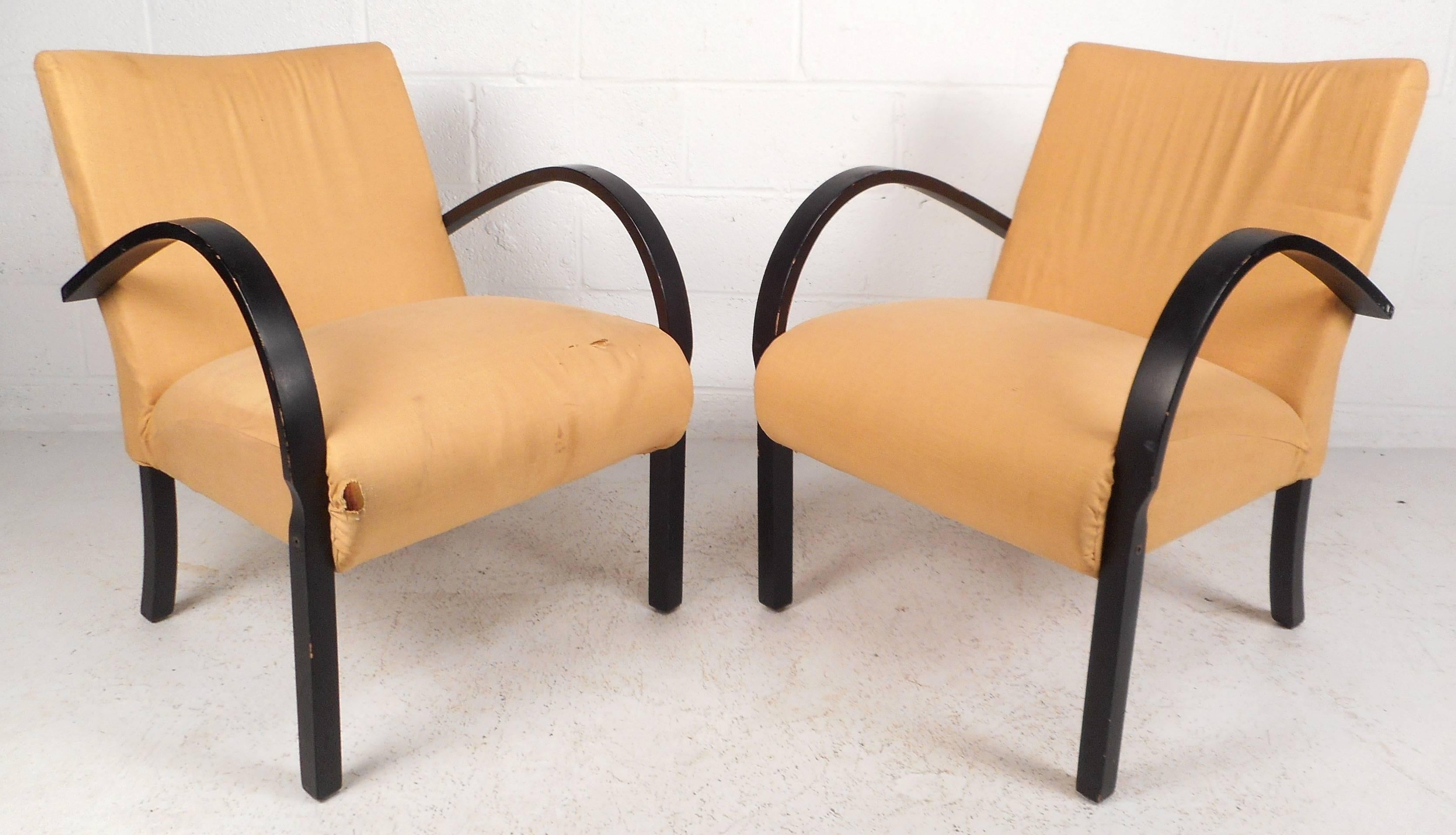 Beautiful pair of vintage modern lounge chairs with unique black rounded arm rests. The sleek and comfortable design with thick padded seating offers comfort in any modern interior. Please confirm item location (NY or NJ).