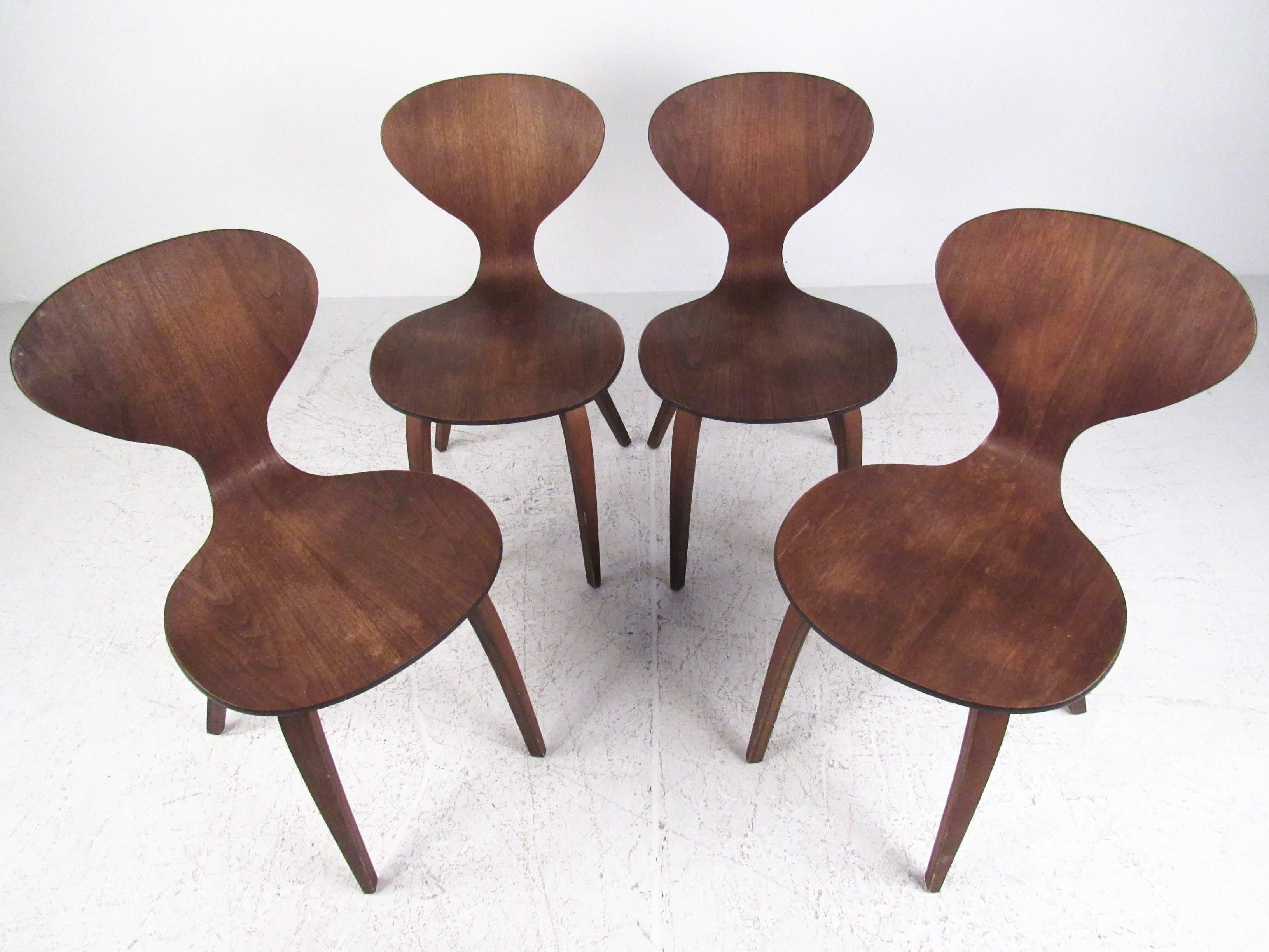 This set of four bentwood dining chairs feature sculptural Norman Cherner style construction with stylish seat backs and comfortable construction. The set of Mid-Century Modern chairs make a beautiful addition to any interior. Please confirm item