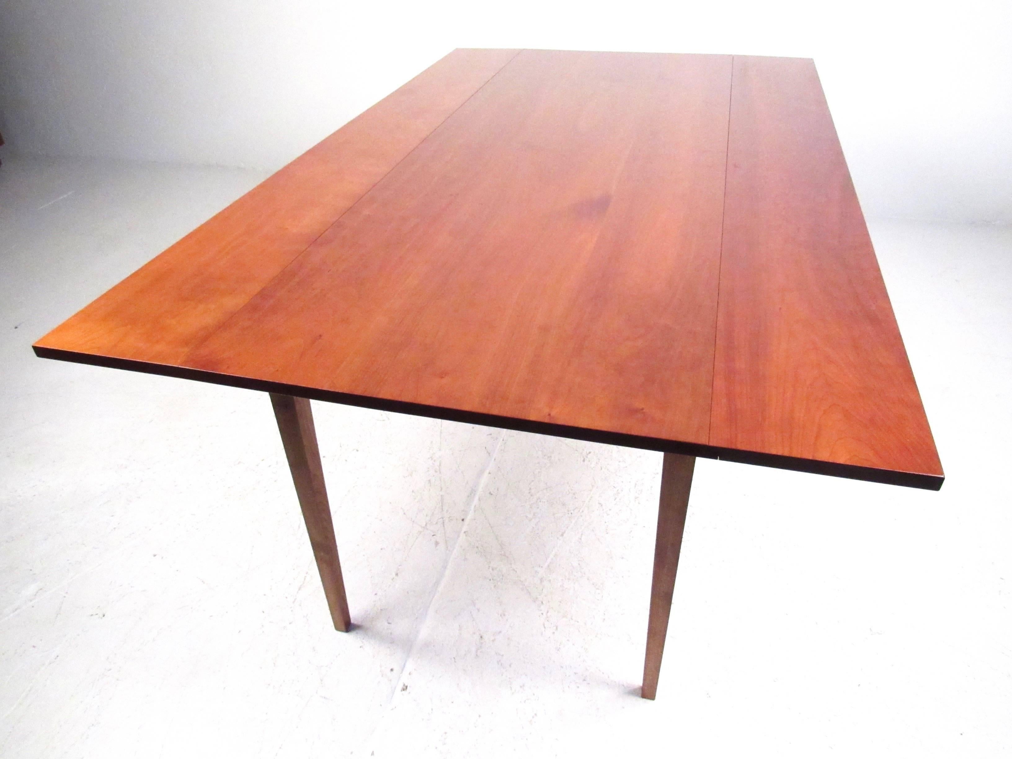 This stylish cherrywood table features exquisite yet simplistic design, with versatile drop leaf function. Ideal table for tight spaces or apartment use . Measures: the 27 inch depth of the table expands to 44 with the leaves opened. Please confirm