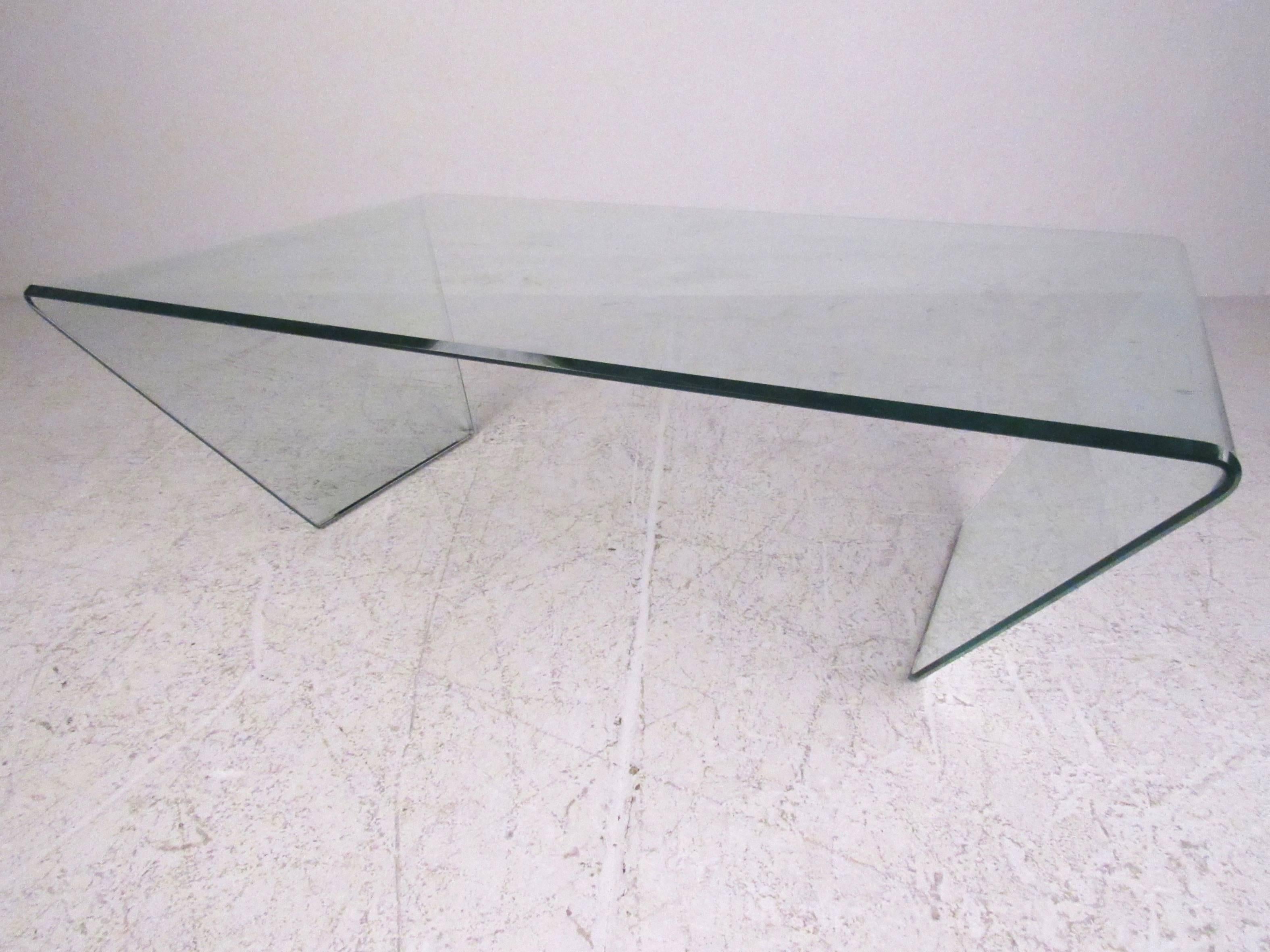 This unique curved glass coffee table features beveled edges and a uniquely angular design, somewhat similar to the iconic waterfall tables designed by Angelo Cortesi for Fiam. Stylish yet simple addition to any interior, please confirm item