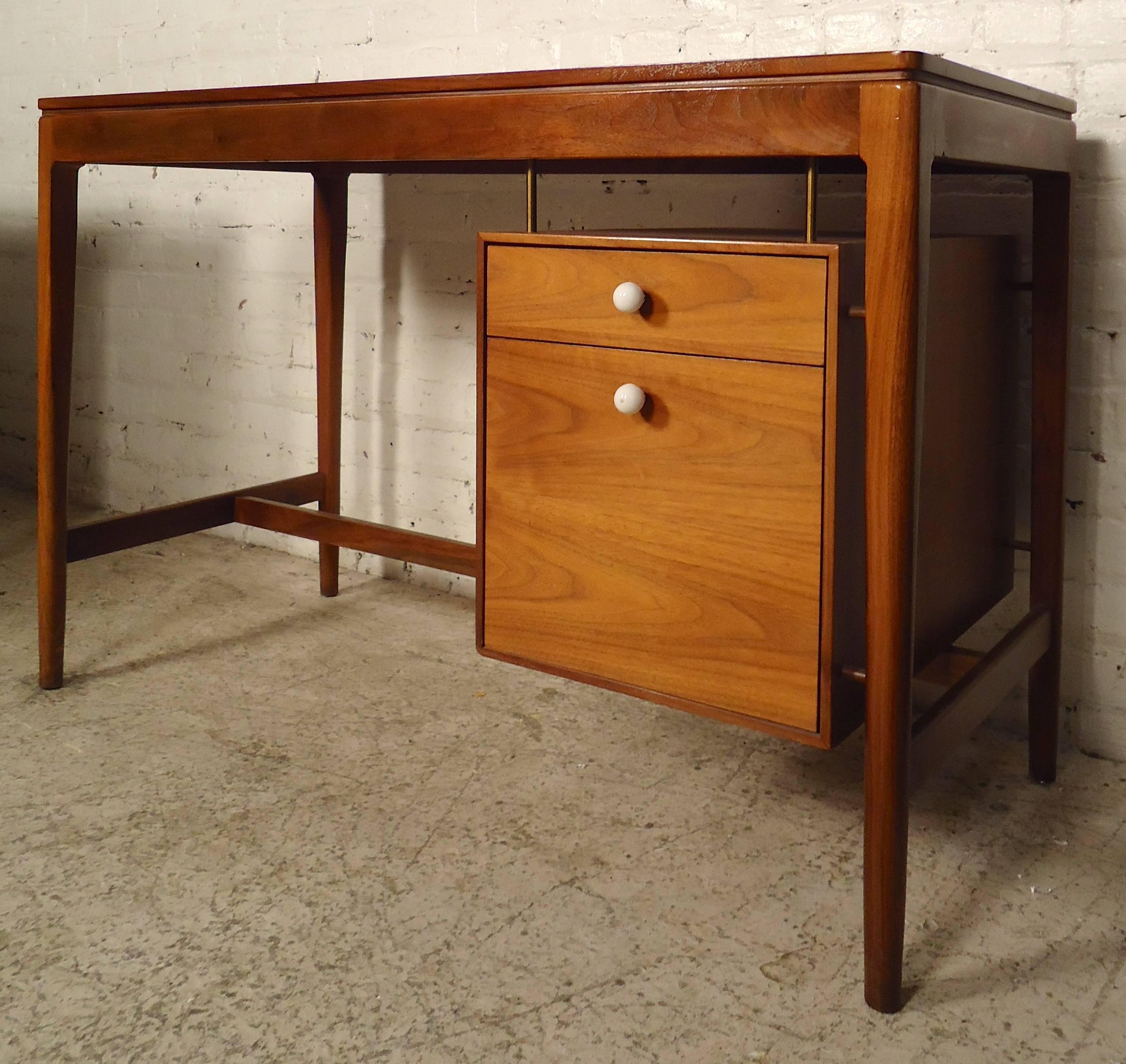 Mid-Century Modern desk by Kipp Stewart for Drexel's Declaration line. Made with warm walnut grain, two floating drawers with glass pulls, finished back and tapered legs.
Measuring kneehole: 26 W x 12 D x 26 H

(Please confirm item location NY or