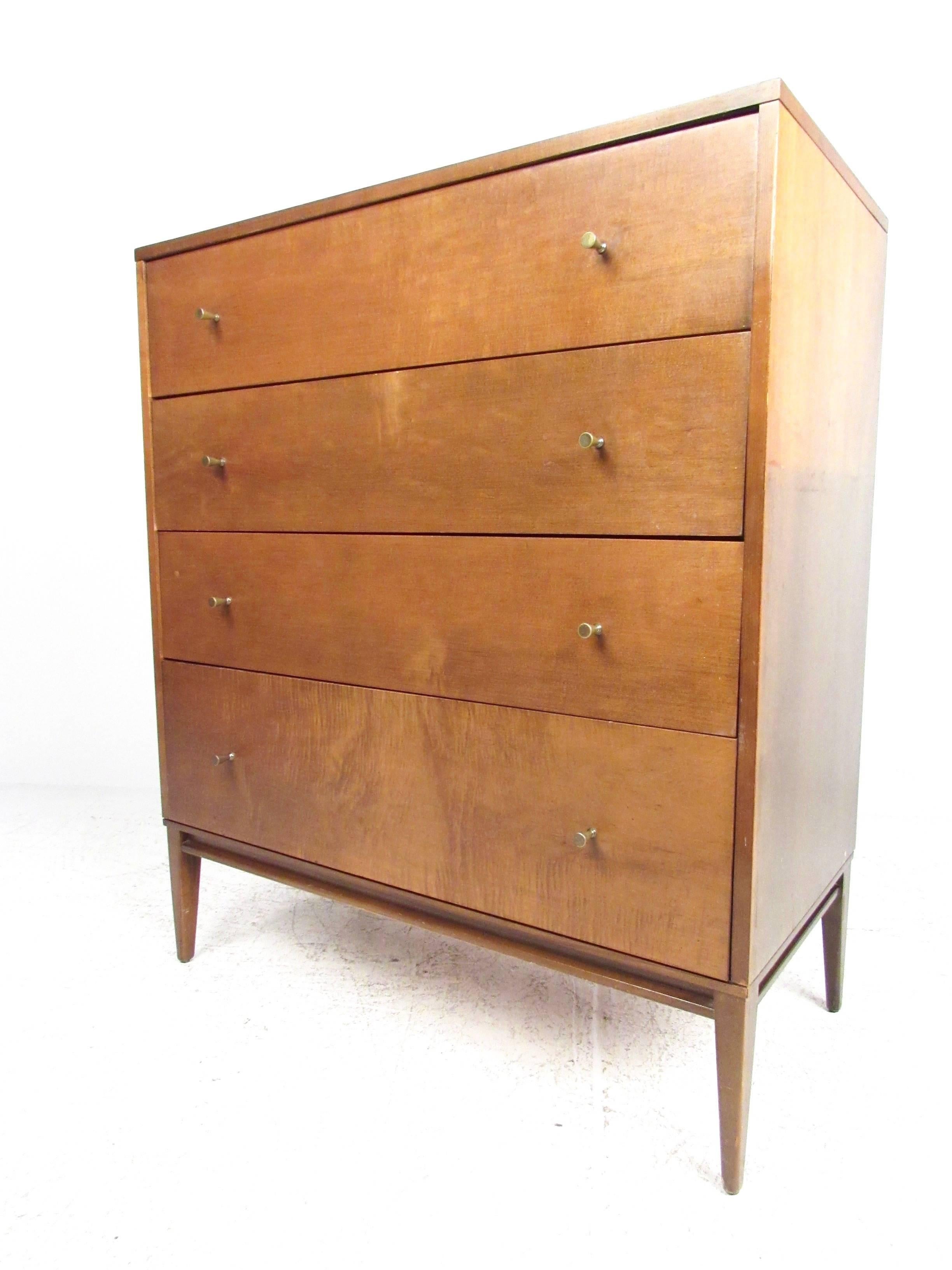 This stylish maple dresser by Paul McCobb for Winchendon boasts a lovely vintage maple finish, Classic McCobb style drawer pulls, and still has the original paper tag attached. Perfect four-drawer dresser for any interior, please confirm item