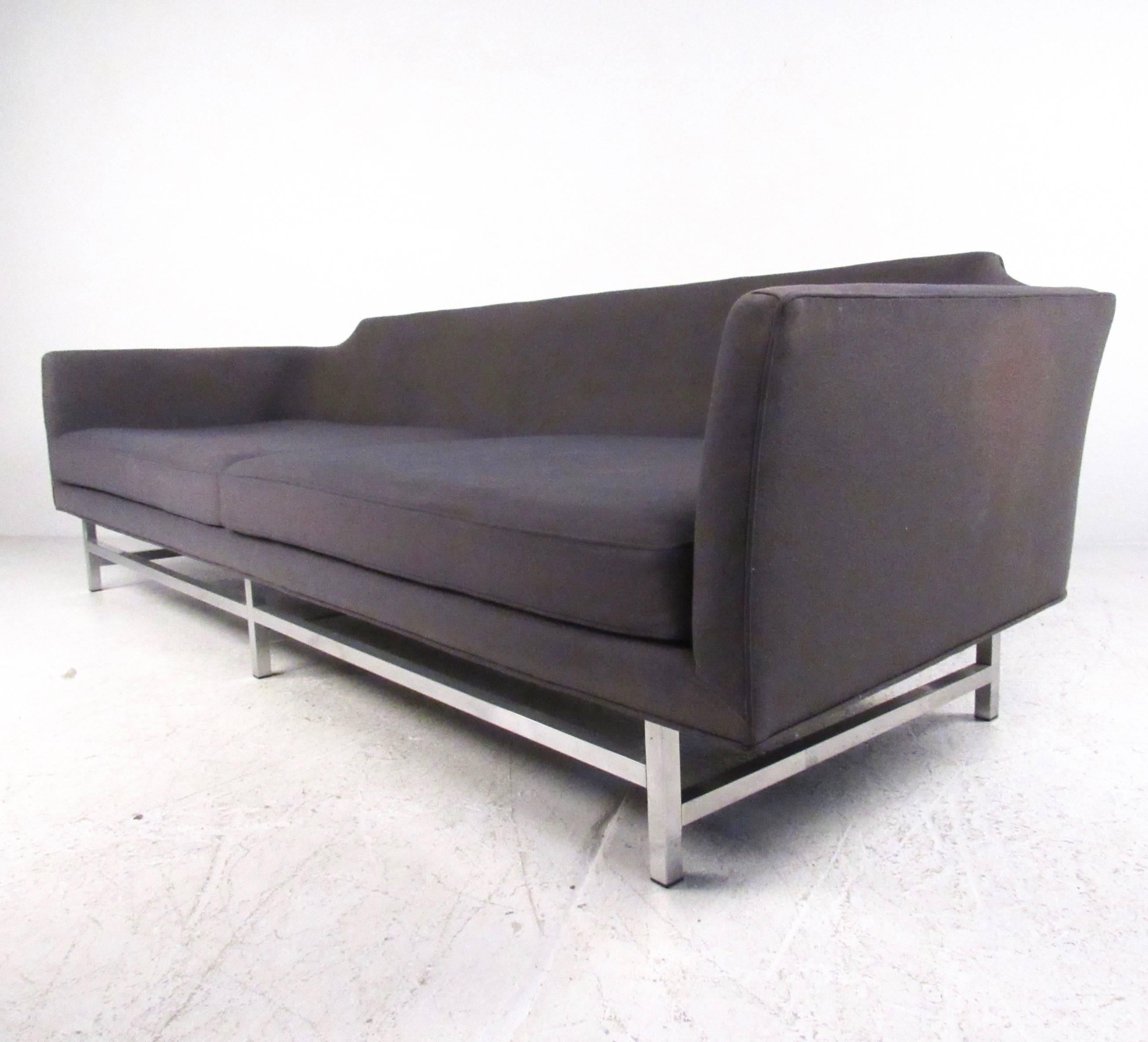 This oversized contemporary modern sofa features Mid-Century style design with unique cutaway back and spacious upholstered seating area. Wonderfully comfortable and long sofa perfect for any seating area. Please confirm item location (NY or NJ).