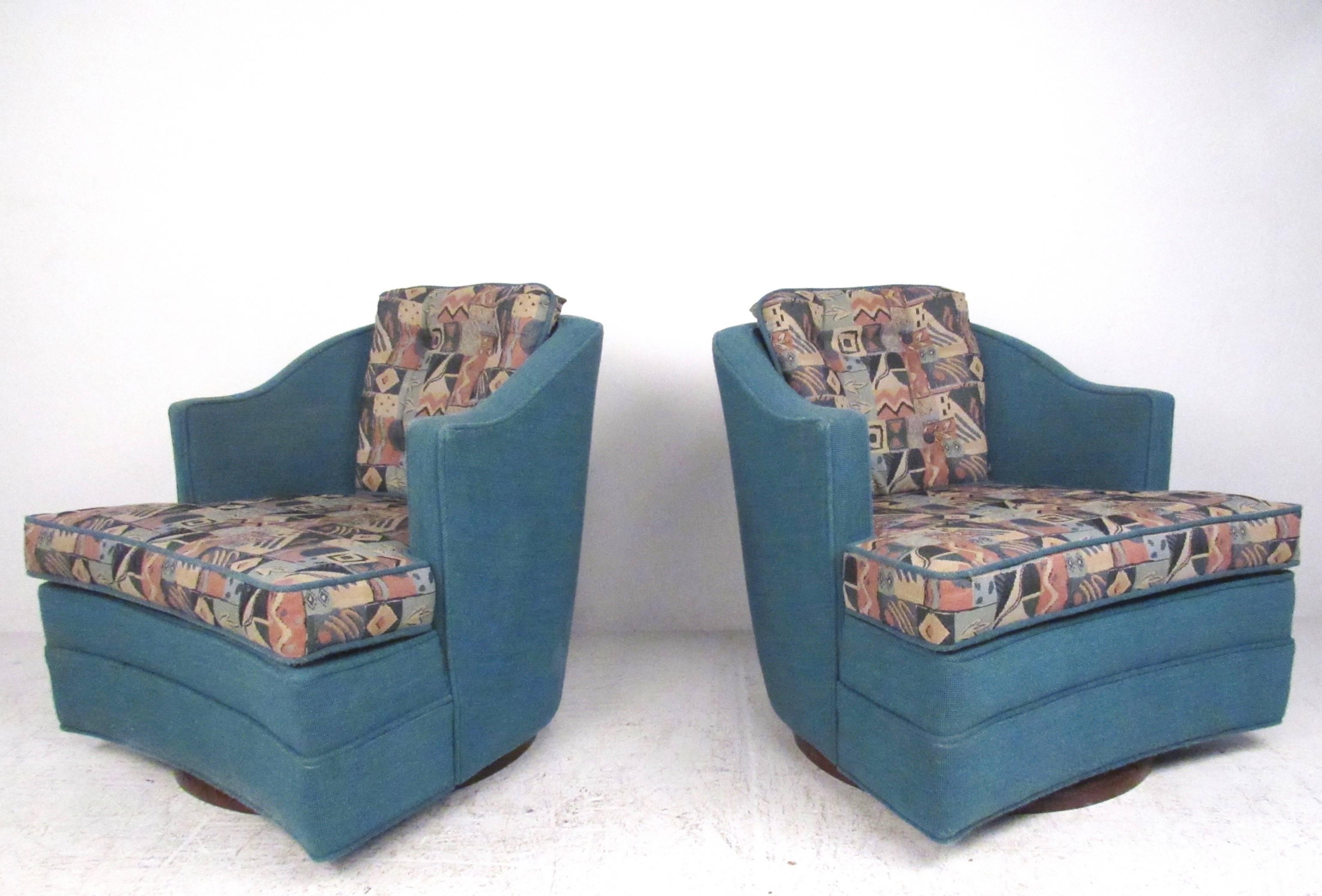 This unique pair of Mid-Century swivel chairs feature two tone vintage fabric and hardwood swivel bases. Comfortable rounded seat backs with tufted upholstery and sculpted arms add to the stylish appeal of this matching pair of club chairs, please