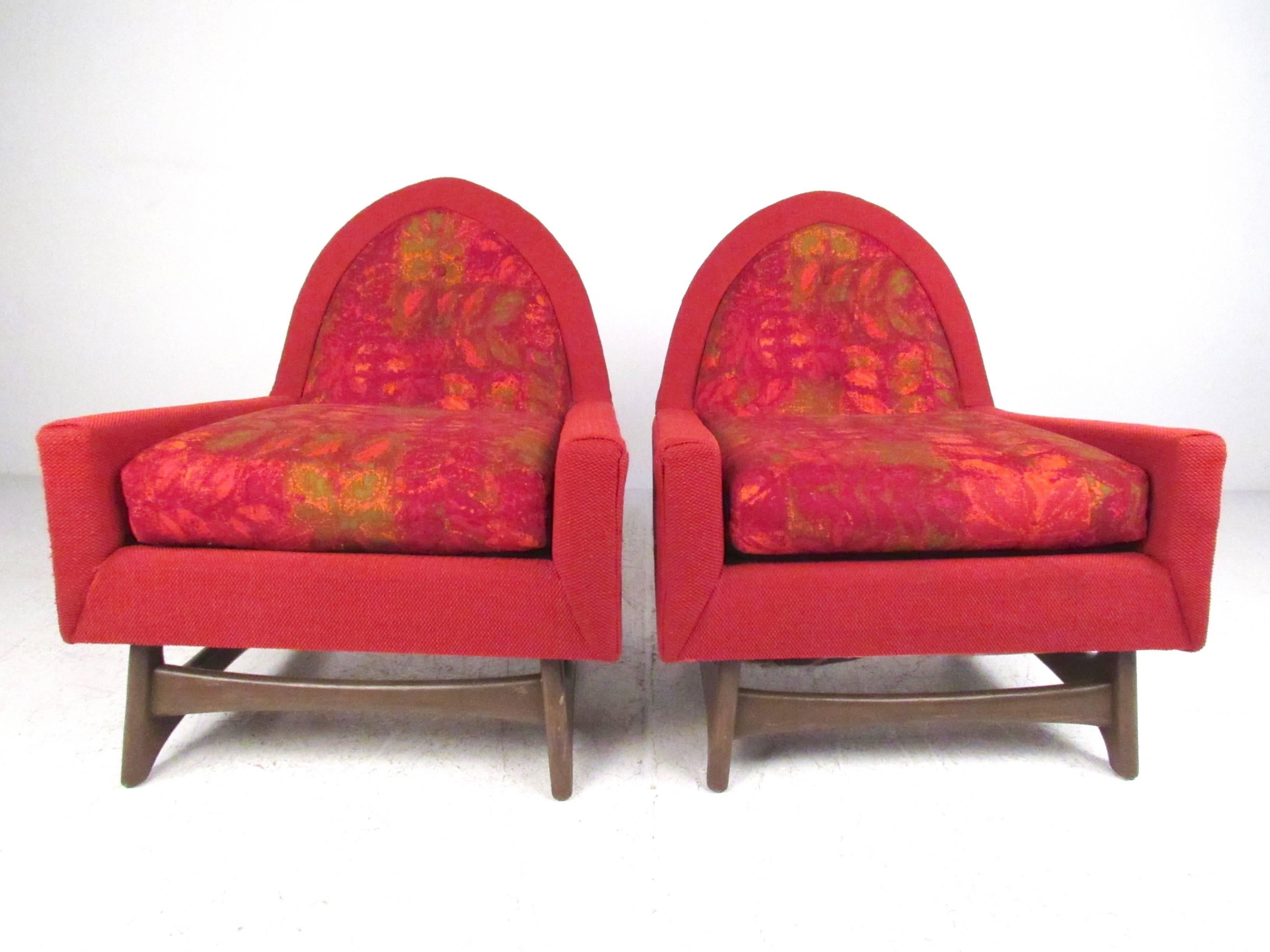 This stylish pair of sculptural lounge chairs in the style of Adrian Pearsall for Craft Associates features unique walnut bases and comfortable upholstered seats. The impressive visual design of the two-tone upholstery on these Mid-Century shaped