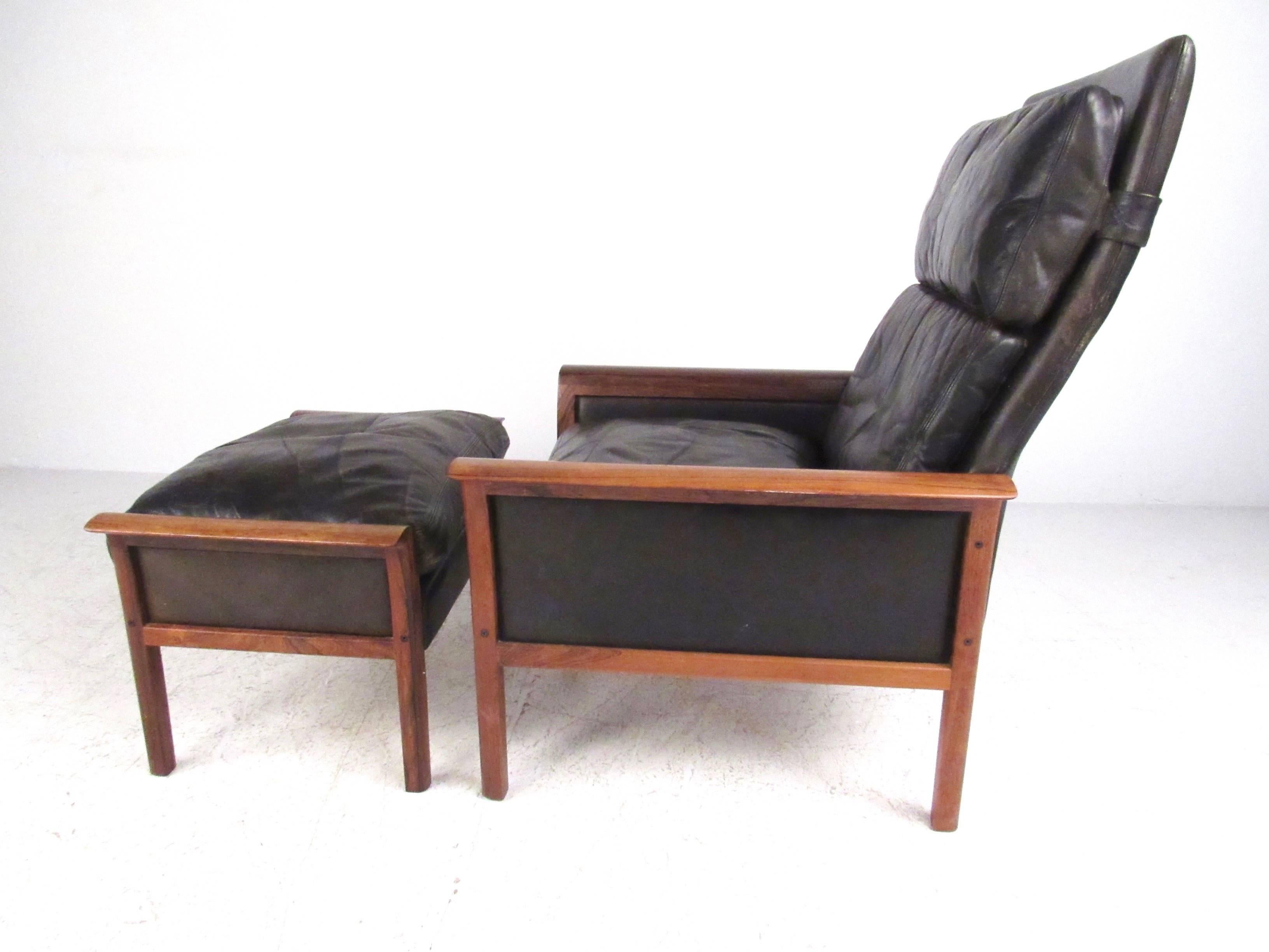 Cette superbe chaise longue norvégienne du milieu du siècle présente un riche cuir vintage et des accoudoirs sculptés avec un cadre en bois de rose bien construit. Le design ergonomique à haut dossier associé à l'ottoman assorti font de cette chaise