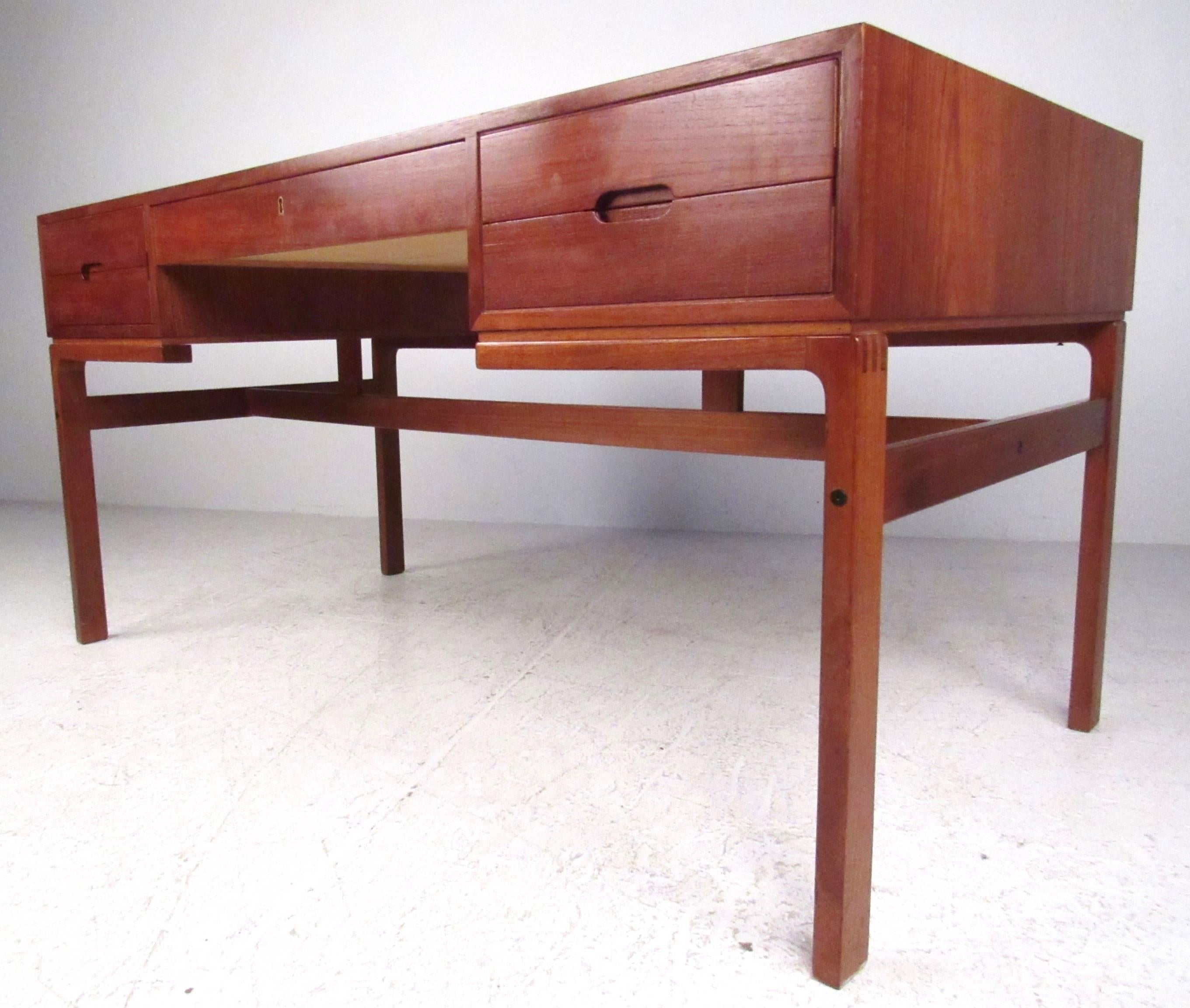 This stylish vintage Scandinavian Modern partner's desk features double sided design with spacious drawer and shelf space for storage. Quality Mid-Century construction includes dovetail joints and beautiful teak finish. Please confirm item location