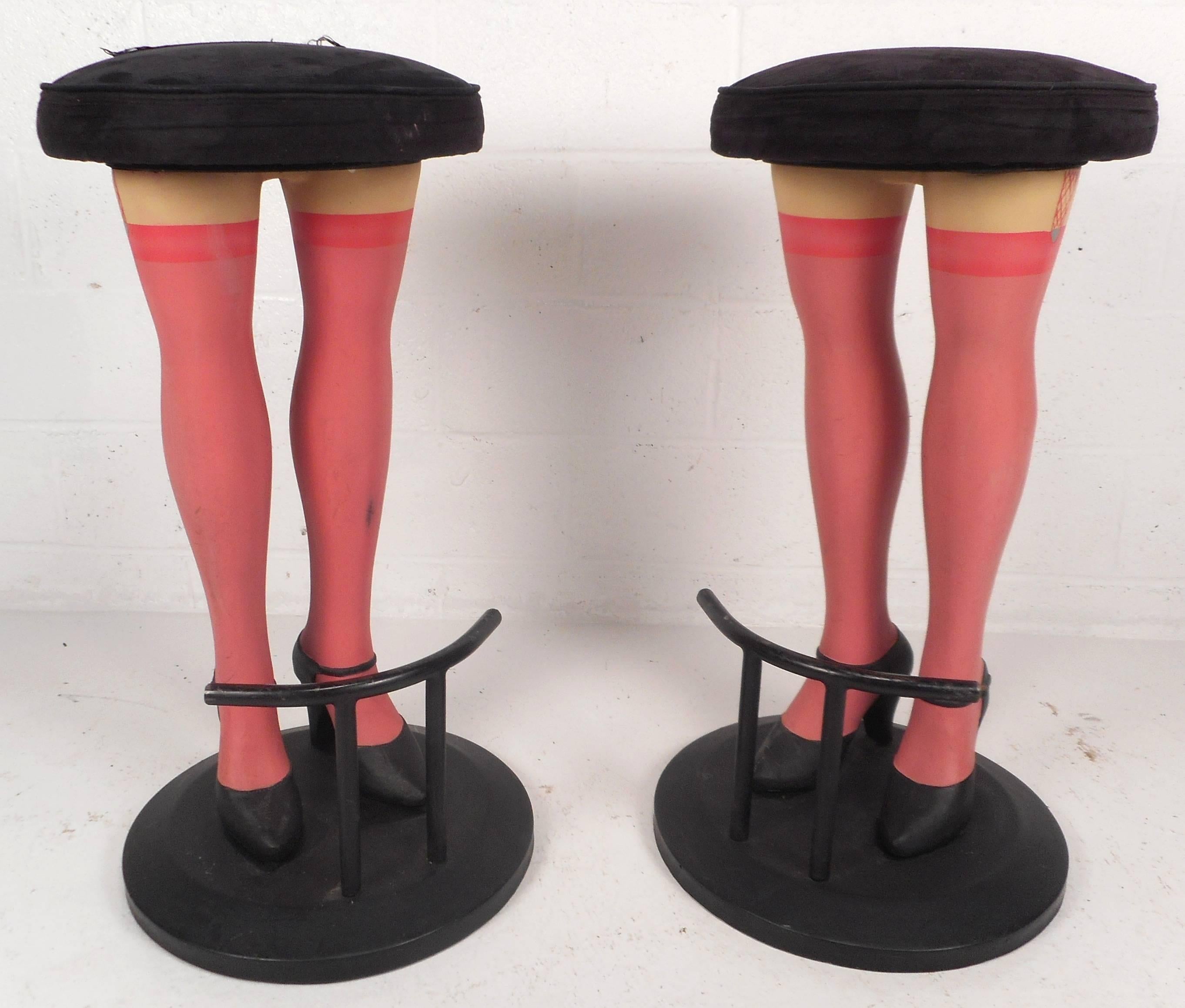 Unusual pair of contemporary modern bar stools feature legs wearing high heels with pink stockings. Incredibly detailed design with a kick rest, sturdy round base, and plush velvet upholstery. This beautiful pair of bar stools are sure to grab