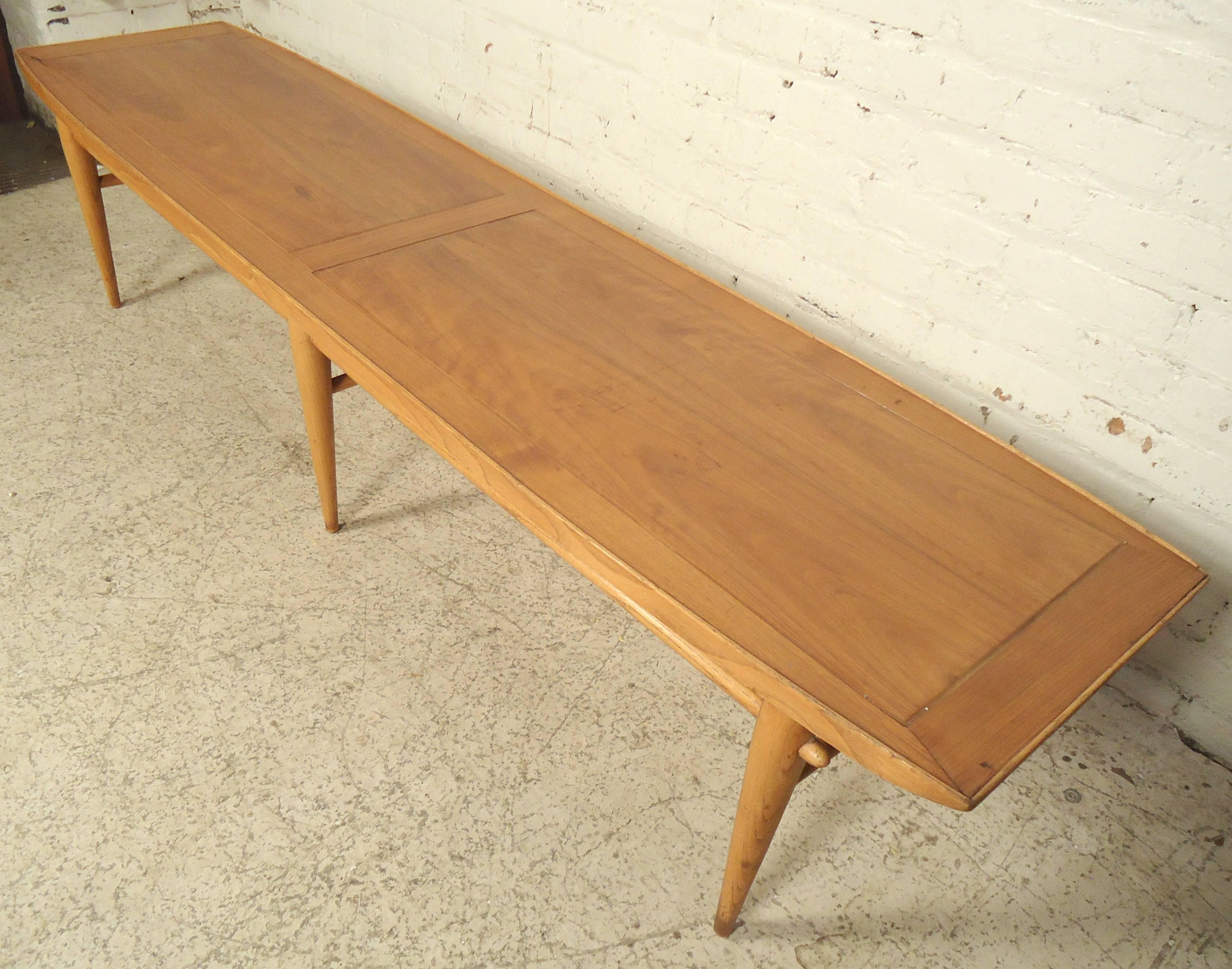 Mid-Century Modern coffee table by Lane with extra-long top and tapered legs. Nice trim around the top and wood stretchers. 

(Please confirm item location - NY or NJ with dealer).
 