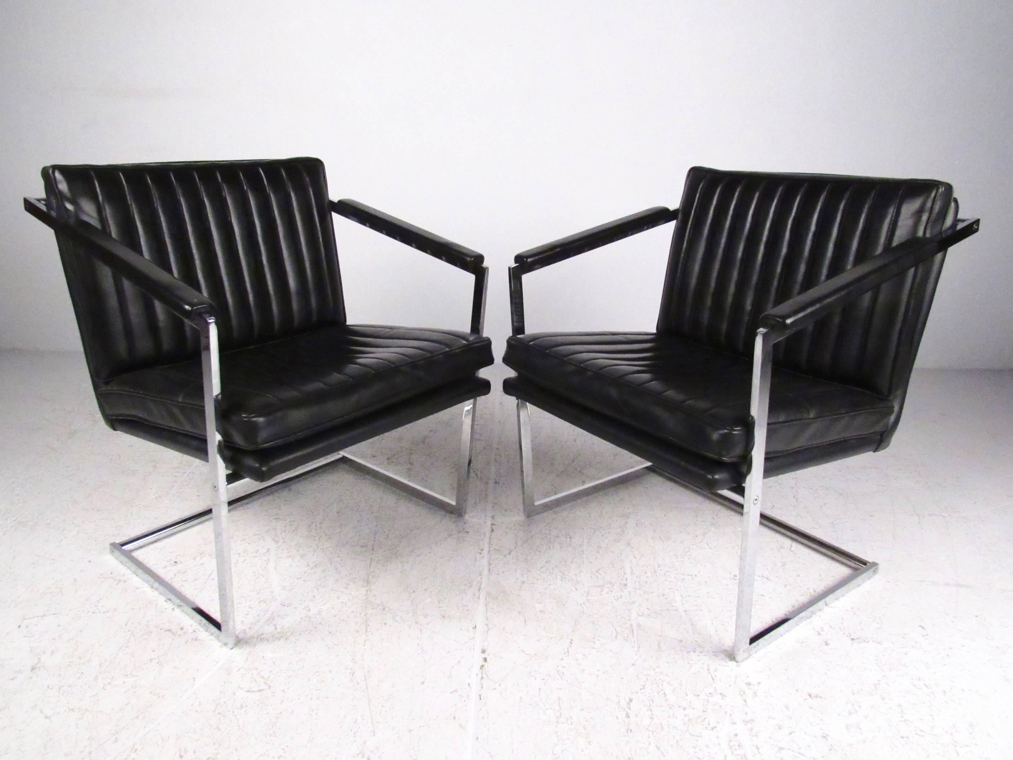 This pair of vintage chrome side chairs features sloped upholstered arms and plush upholstered seats. The stylish modern appeal of this well-crafted pair of arm chairs make this vinyl and heavy chrome set the perfect addition to home office seating.