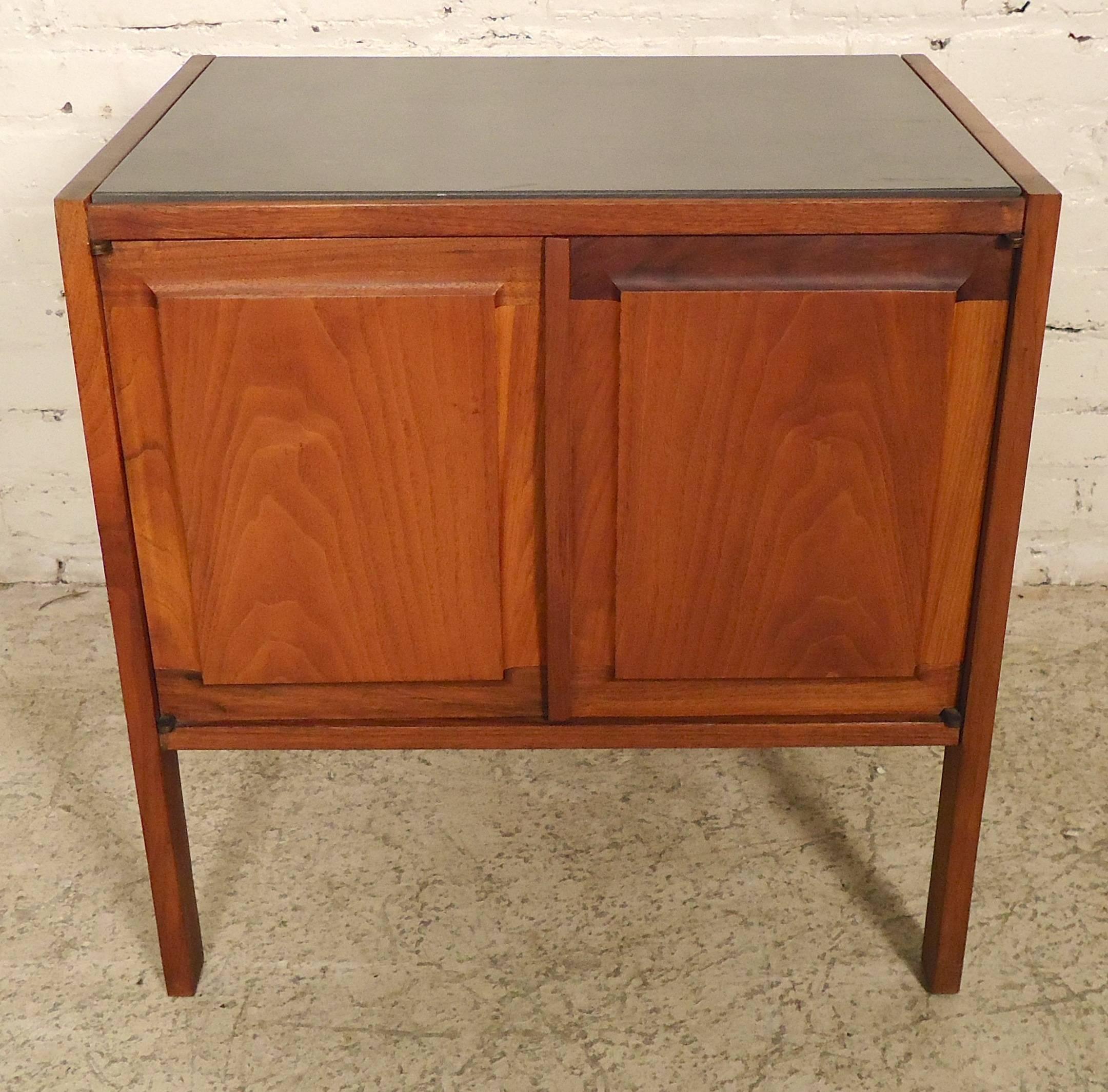 Unusual stone top bedside table with warm teak grain. Attractive two-door table with finished sides and back with open cabinet and drawer storage.

(Please confirm item location - NY or NJ with dealer).
 