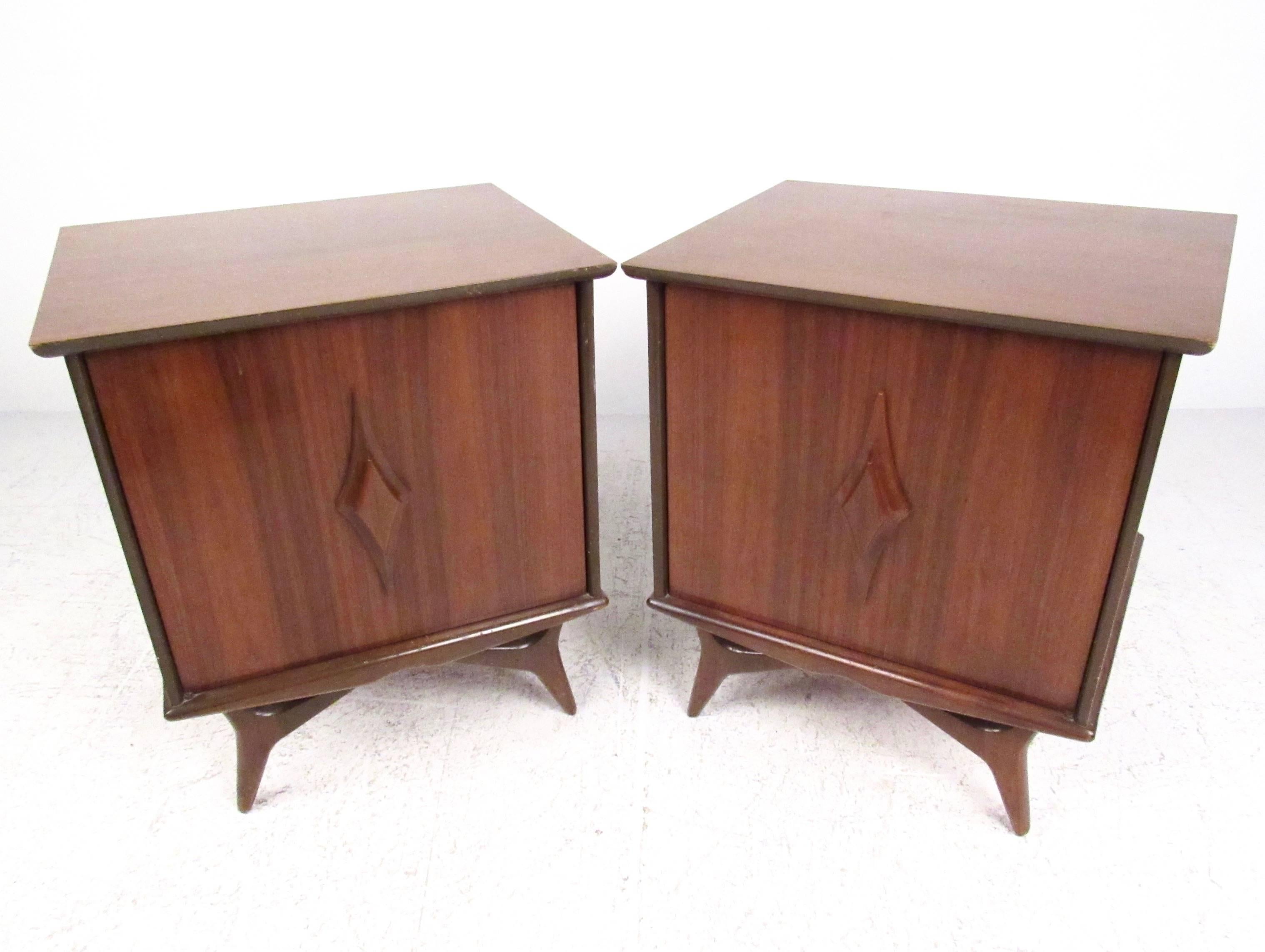 This stunning pair of vintage walnut nightstands features sculpted door fronts, tapered legs, and spacious interior cabinets. Adjustable shelves make this matching pair the perfect addition to bedroom or living room, allowing for stylish end table