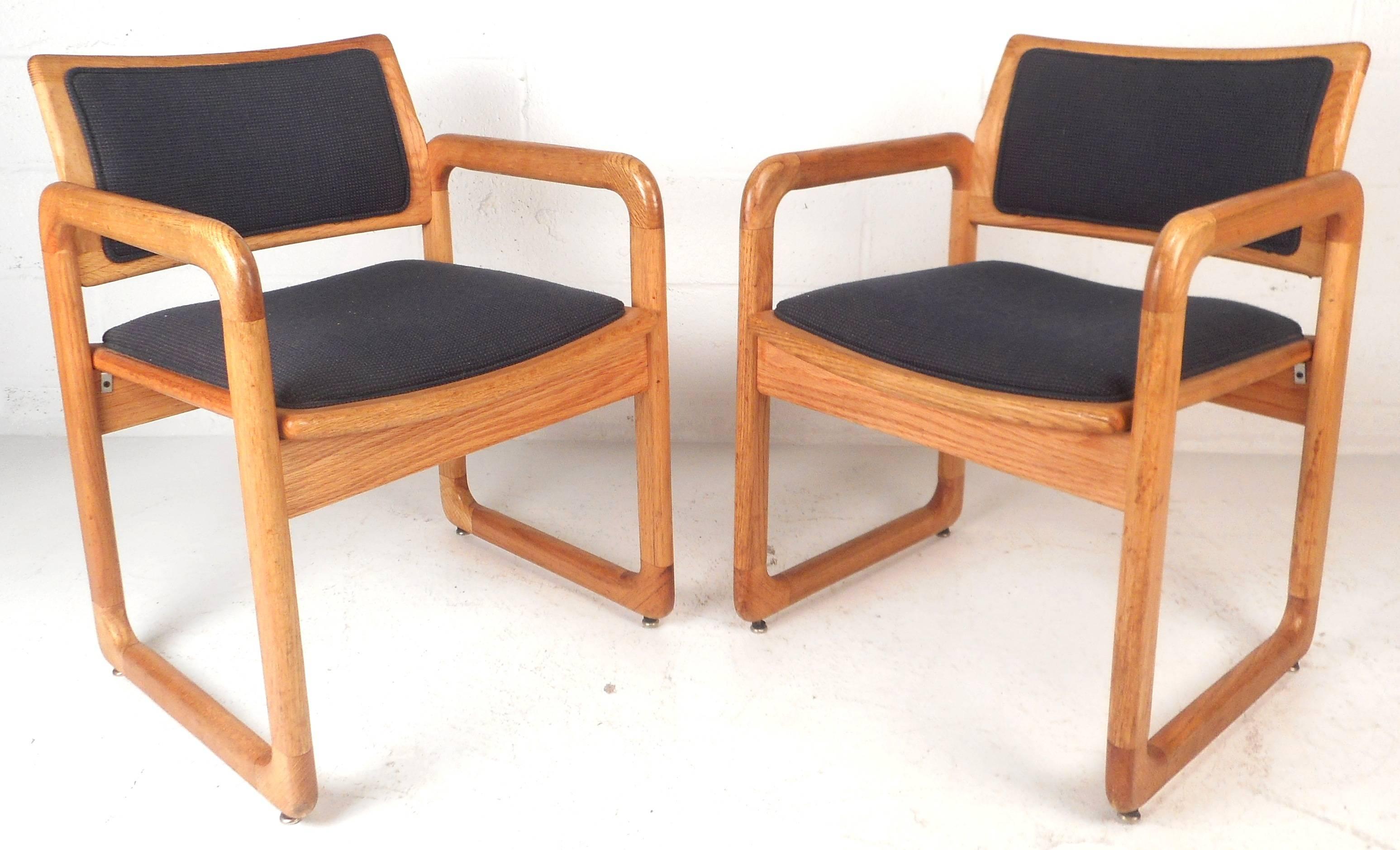This stunning pair of vintage modern arm chairs feature unique 