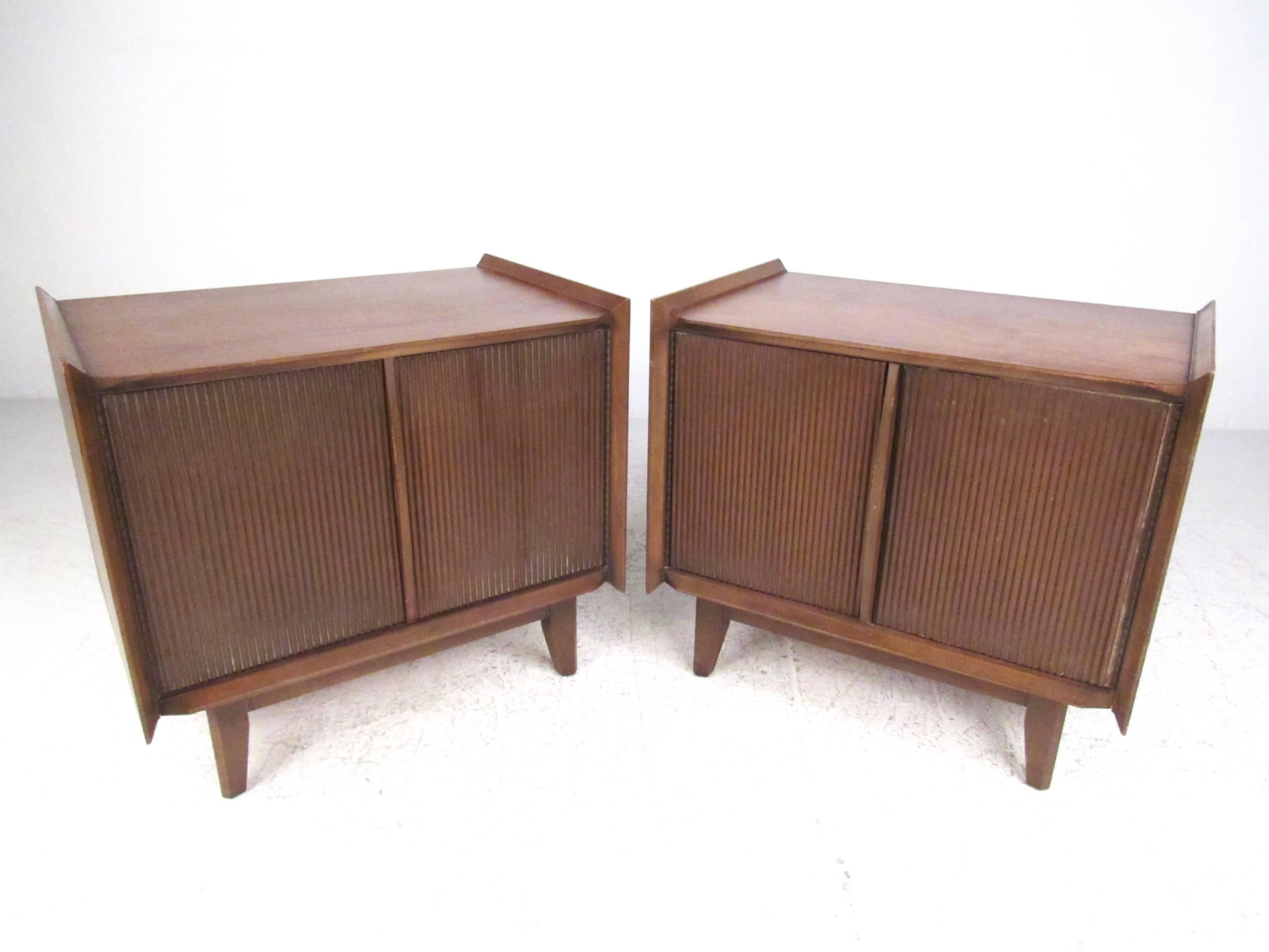 This vintage pair of sculpted front walnut nightstands make a stylish addition to decor in any interior. From bedside lamp table to occasional storage for living room or office, the matching pair offers open cabinet storage and features iconic