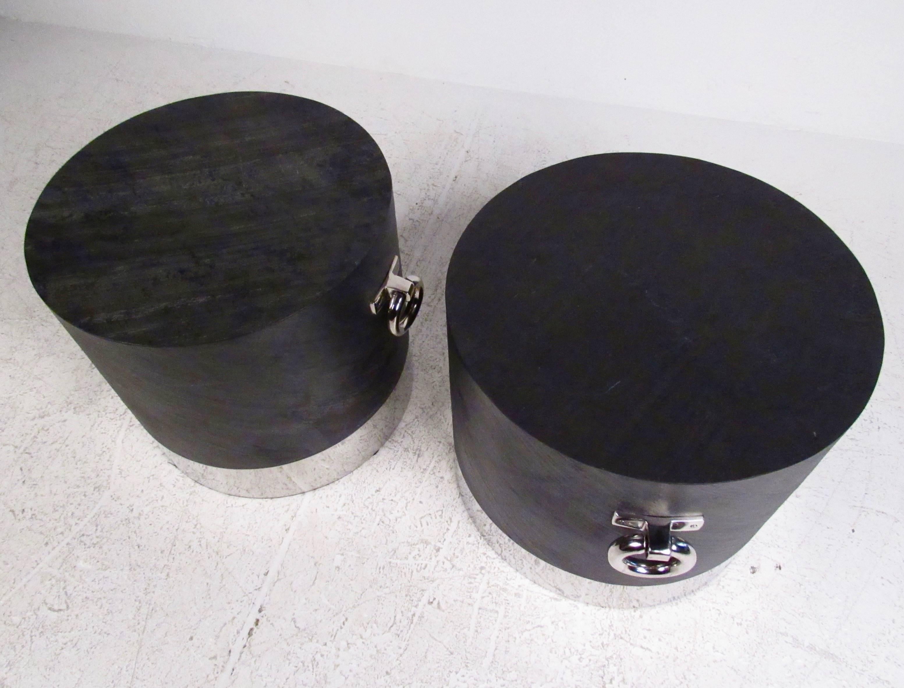 This unique pair of modern circular end tables make excellent lamp tables, sofa end tables, or occasional pedestals. Stylish chrome handles and trim add to the appeal of the matching pair, which feature a textured faux-slate finish. Please confirm