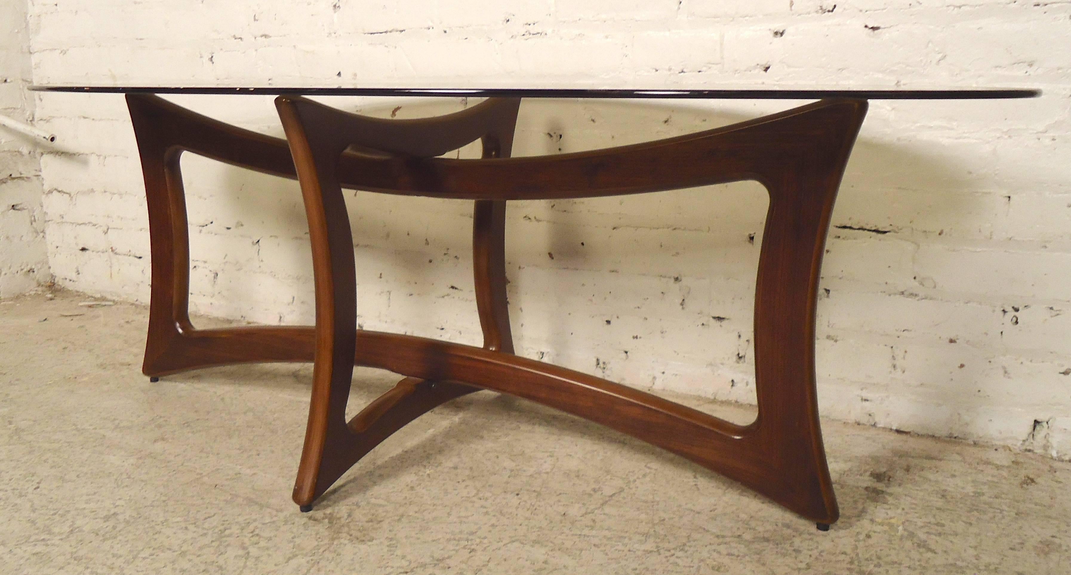 Beautiful sculpted wood table base with a smoked glass oval top. Simple and elegant living room table that will also show off your hardwood floor or decorative rug.

(Please confirm item location - NY or NJ - with dealer).
 