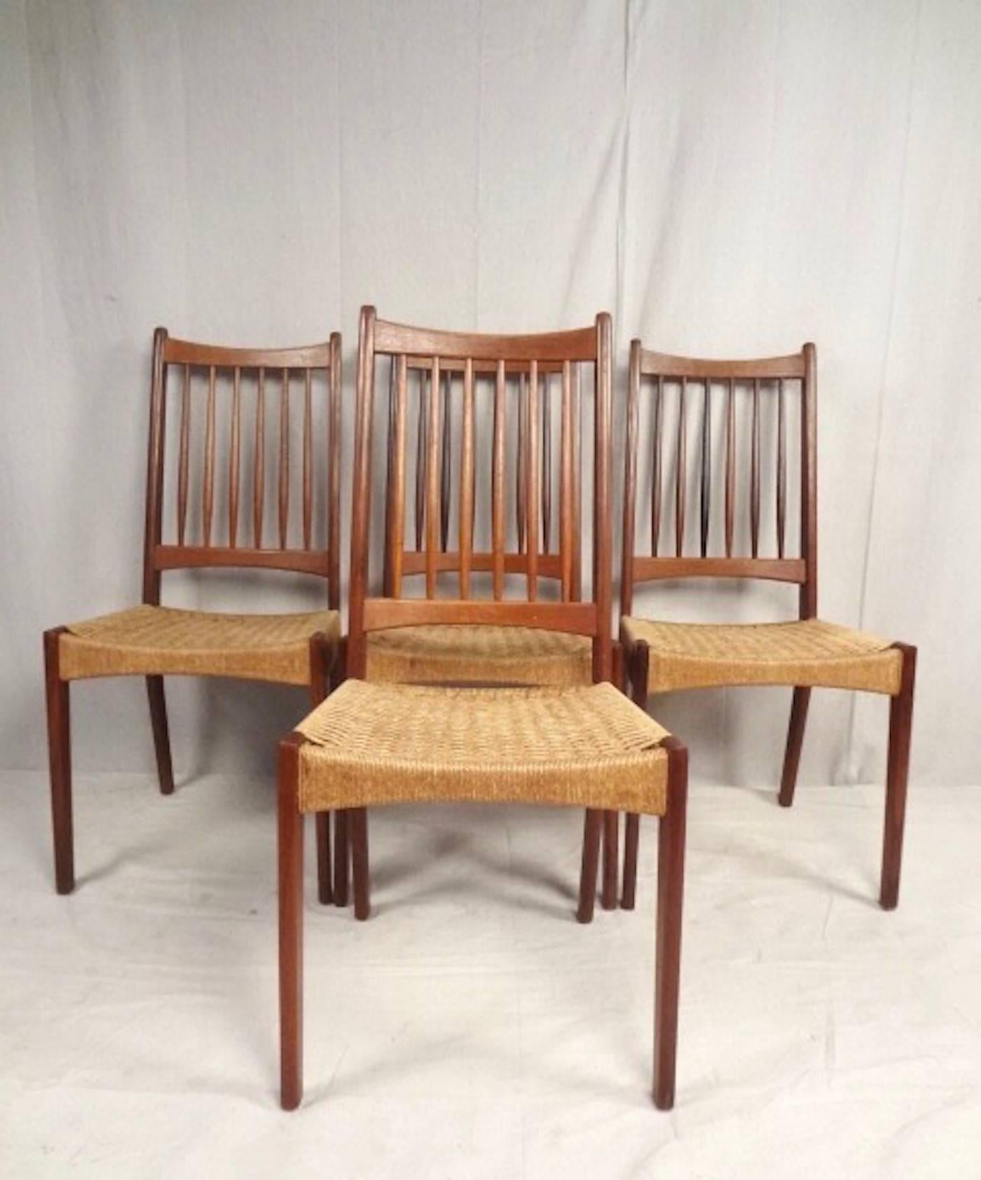 This stylish set of four spindle back dining chairs are constructed from vintage Danish teak in the style of Hans Wegner, and feature shape seat backs and rope cord seats. This beautiful matching set of Mid-Century chairs make a stylish addition to
