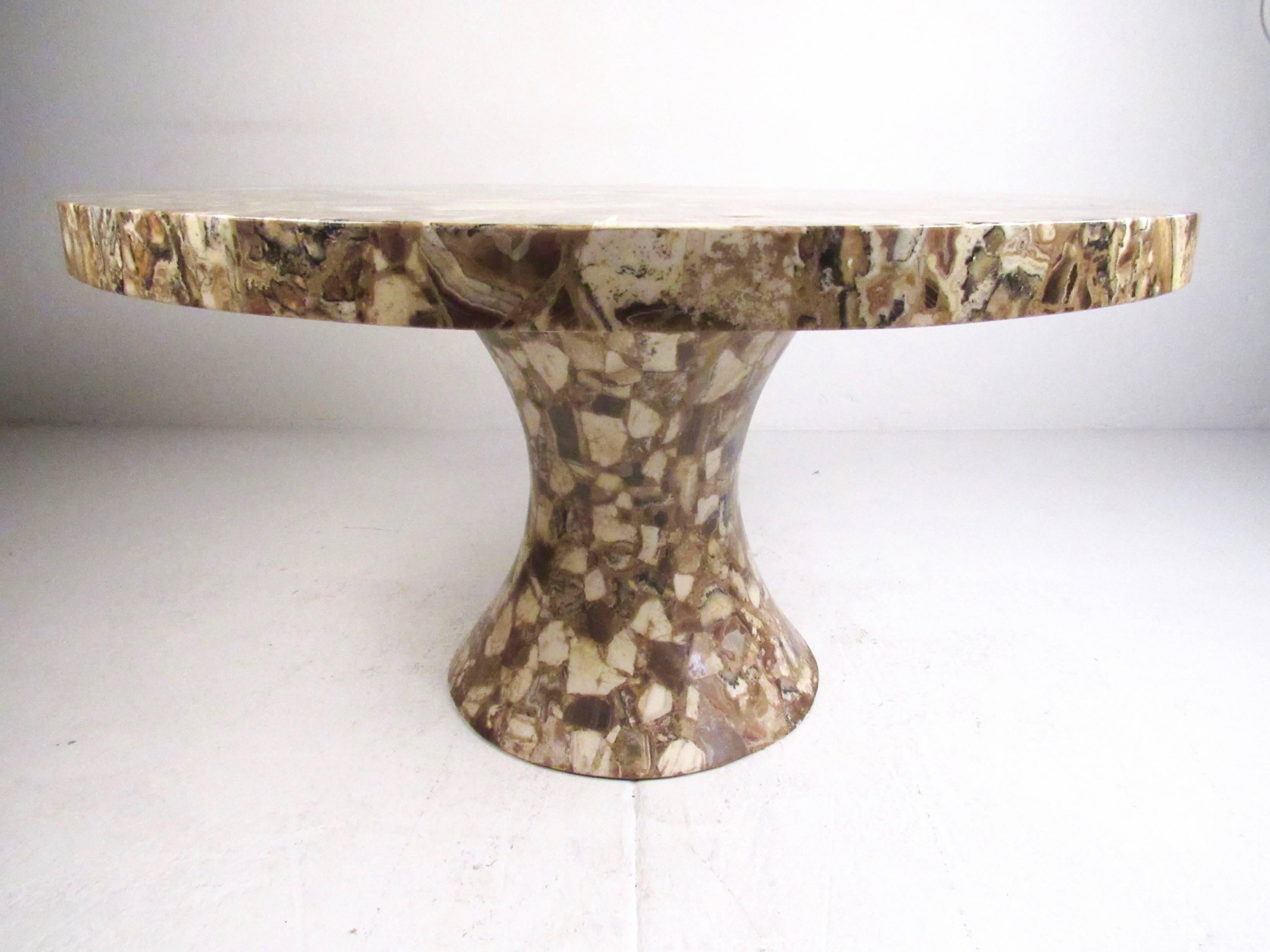 This stunning pedestal dining table features a beautiful mosaic onyx finish with a sculpted pedestal base. An impressive center table in any setting, this vintage Muller's Onyx table makes a stylish and unique addition to any home. Please confirm