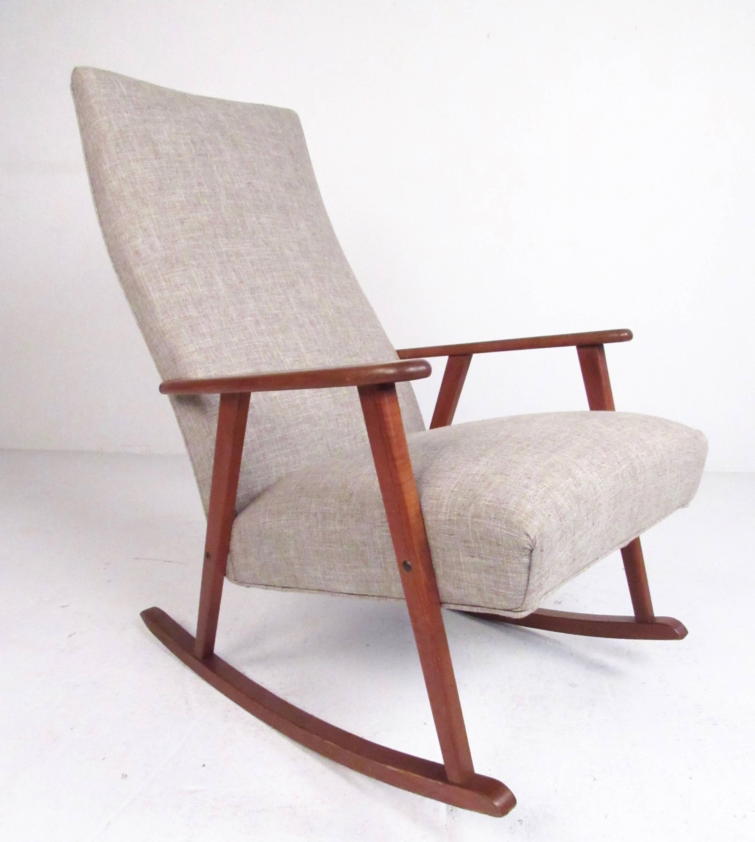 This stylish Scandinavian Modern rocking chair features a well-crafted teak frame and upholstered high back seat. Simple elegance combines mid-century design with timeless comfort, making this the perfect rocker for any setting. Please confirm item