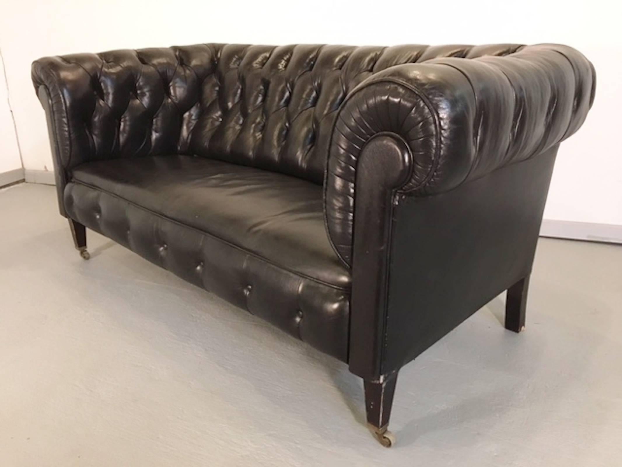 Vintage chesterfield sofa set with original black leather. Long sofa and two club chairs, complete with tufted backs, rolled arms and caster legs.
Measures: Sofa: 32” H x 72" W x 34" D seat height 18"
chairs: 32" H x 37.5"