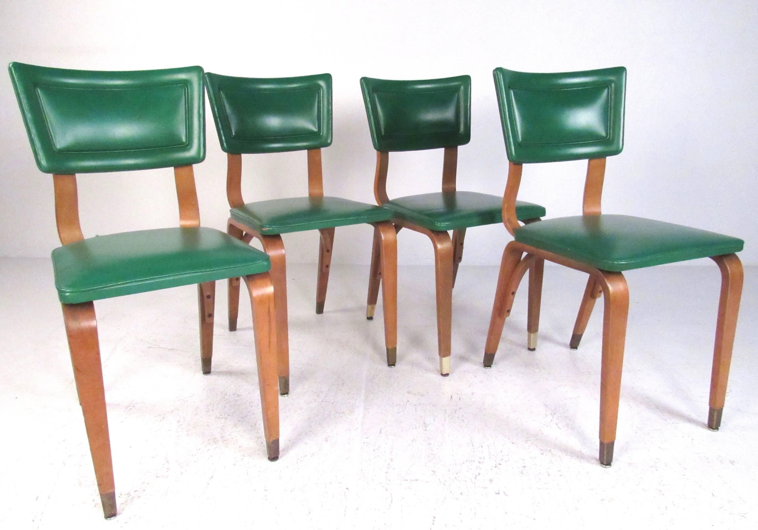 This stylish set of four bentwood dining chairs features green vinyl upholstery, sculpted bent-ply frames with unique tapered legs. The brass sabot feet add to the mid-century charm of the set, please confirm item location (NY or NJ). 