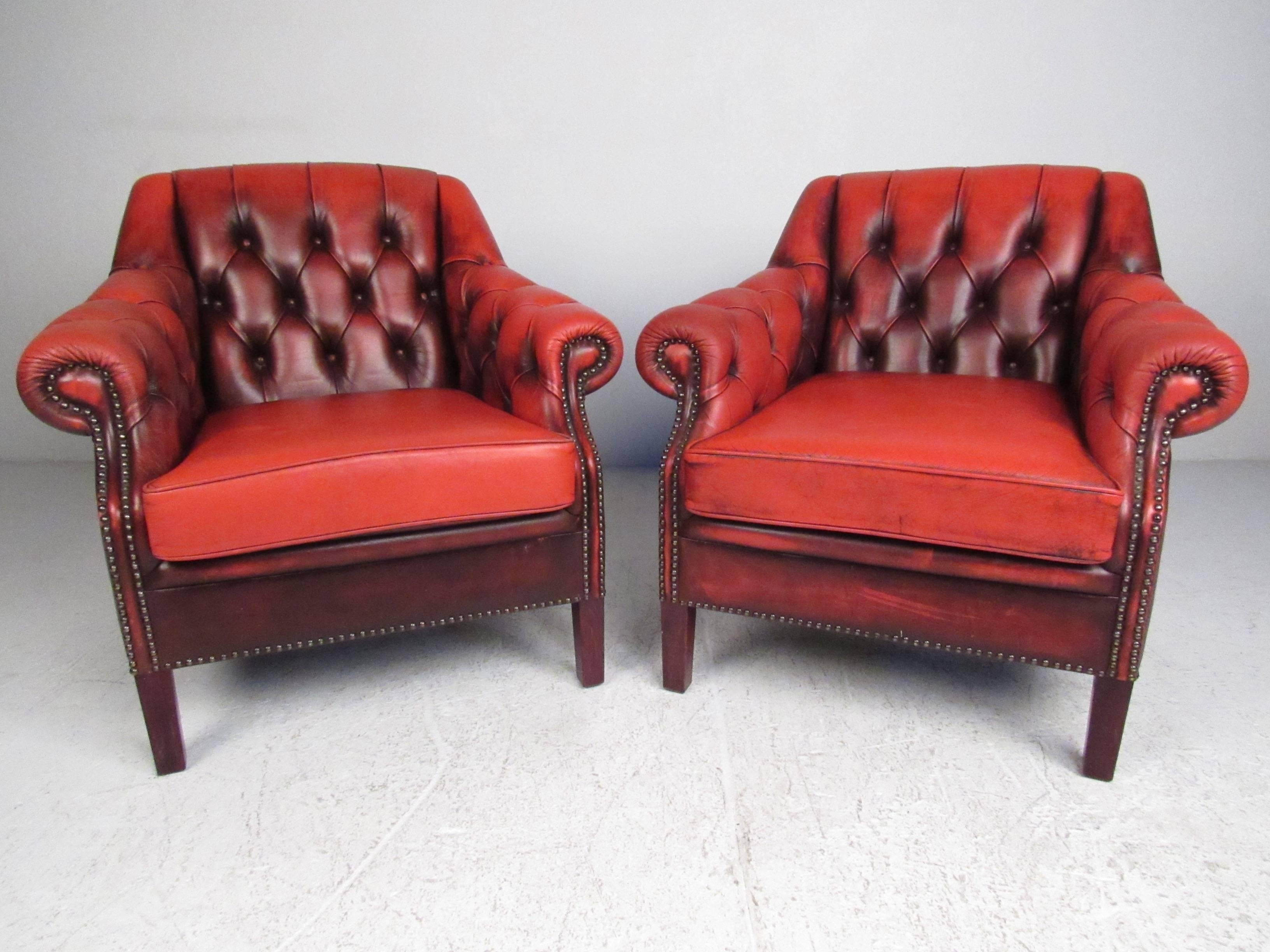 This unique three-piece Chesterfield living room set includes a stylish red leather sofa and pair of matching armchairs. Rich patinated leather is complimented by deep tufts, upholstery buttons, and scrolled arms, while tapered hardwood legs provide