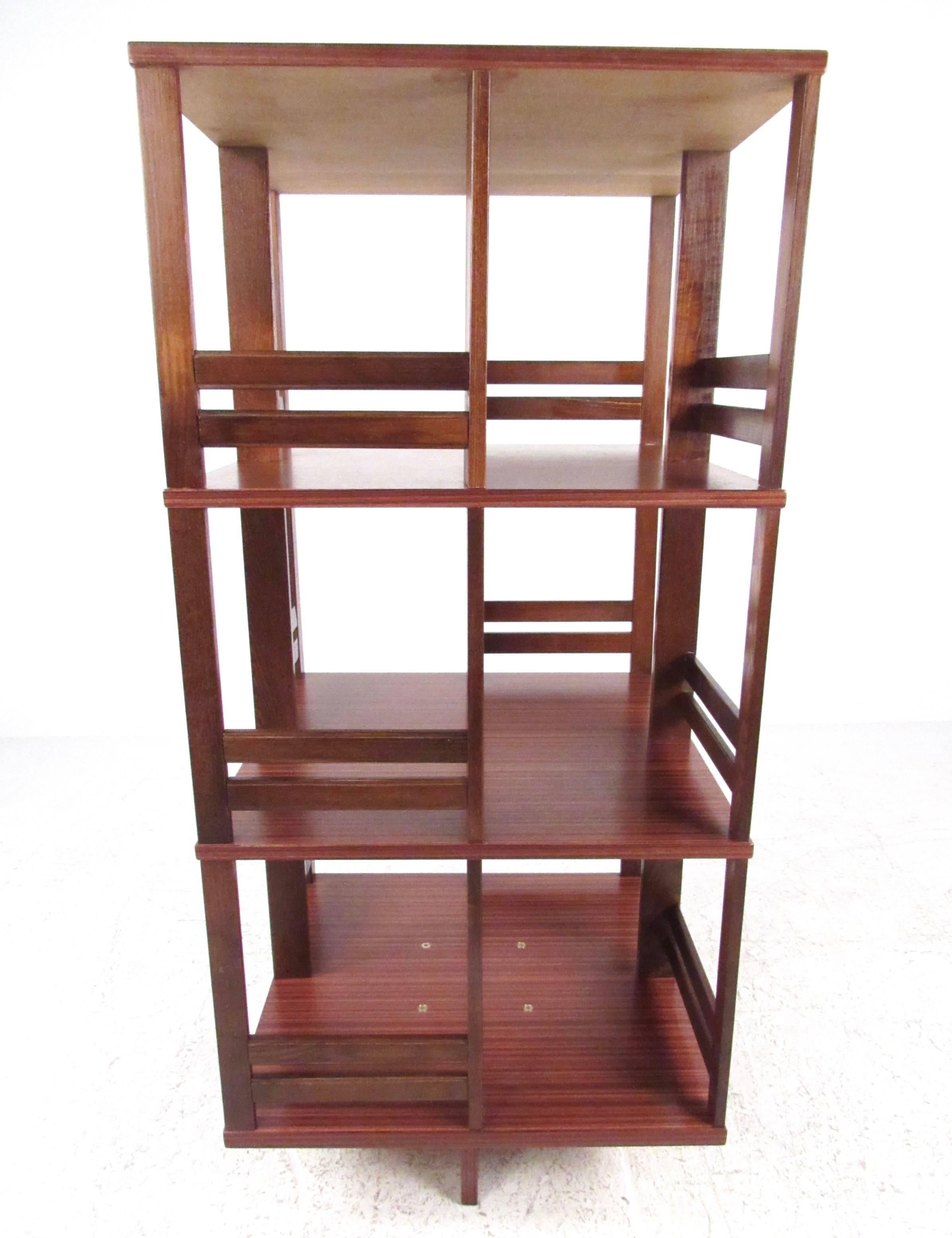 This stylish multi-tier bookshelf makes a unique storage piece for any setting. Idea for media storage or shop display, this unique wood finish shelf unit is perfect for home or business use. Please confirm item location (NY or NJ).