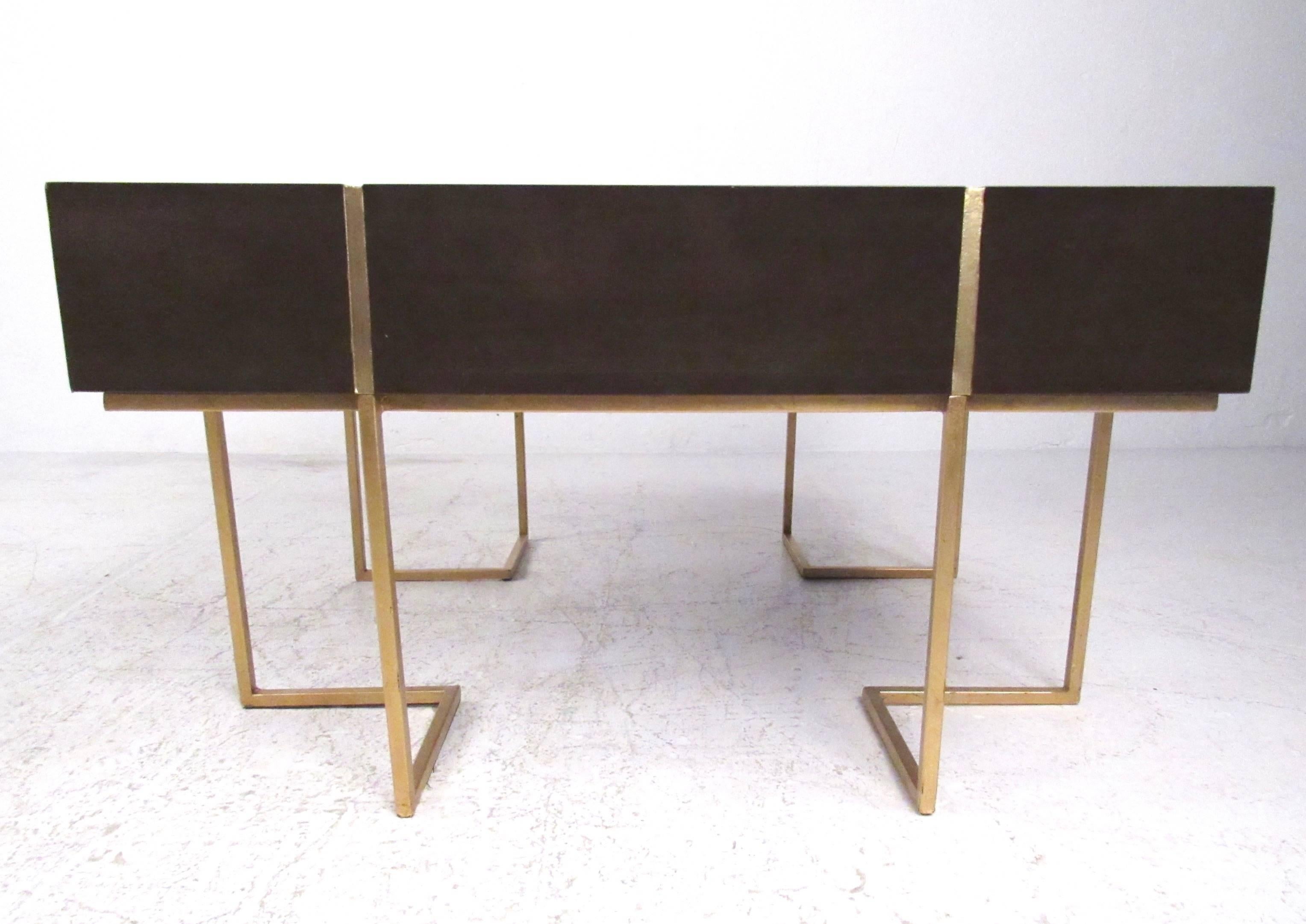 This stylish hardwood coffee table features a unique sculptural gold painted base with stylish inlay and impressive design. The clean modern lines on this vintage square coffee table make this a wonderful Mid-Century addition to any interior. Please