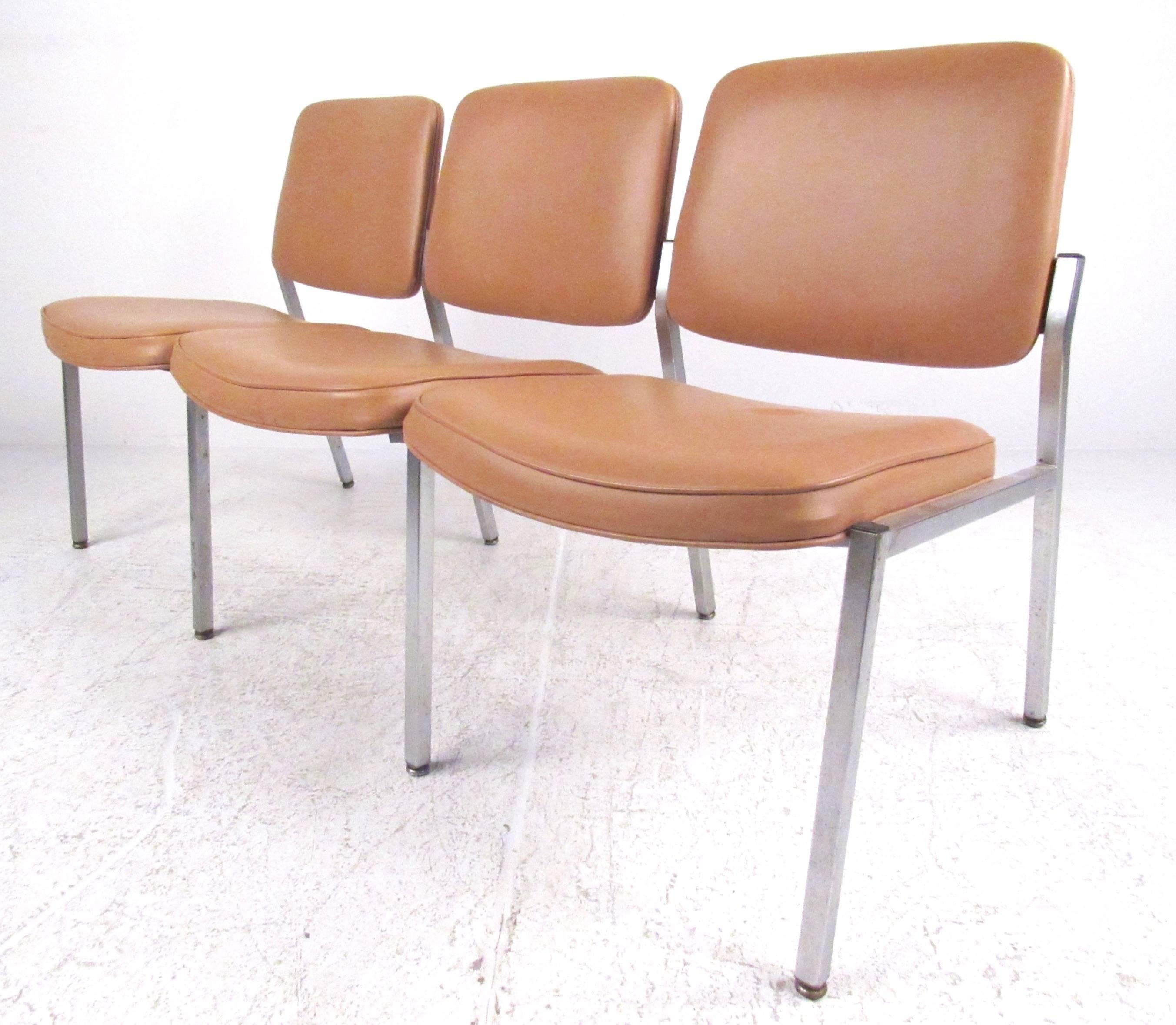 This Mid-Century waiting room bench features stylish vinyl seats with sturdy metal frame. Vintage three seat design makes this unique vintage bench a stylish addition to any interior. Please confirm item location (NY or NJ).