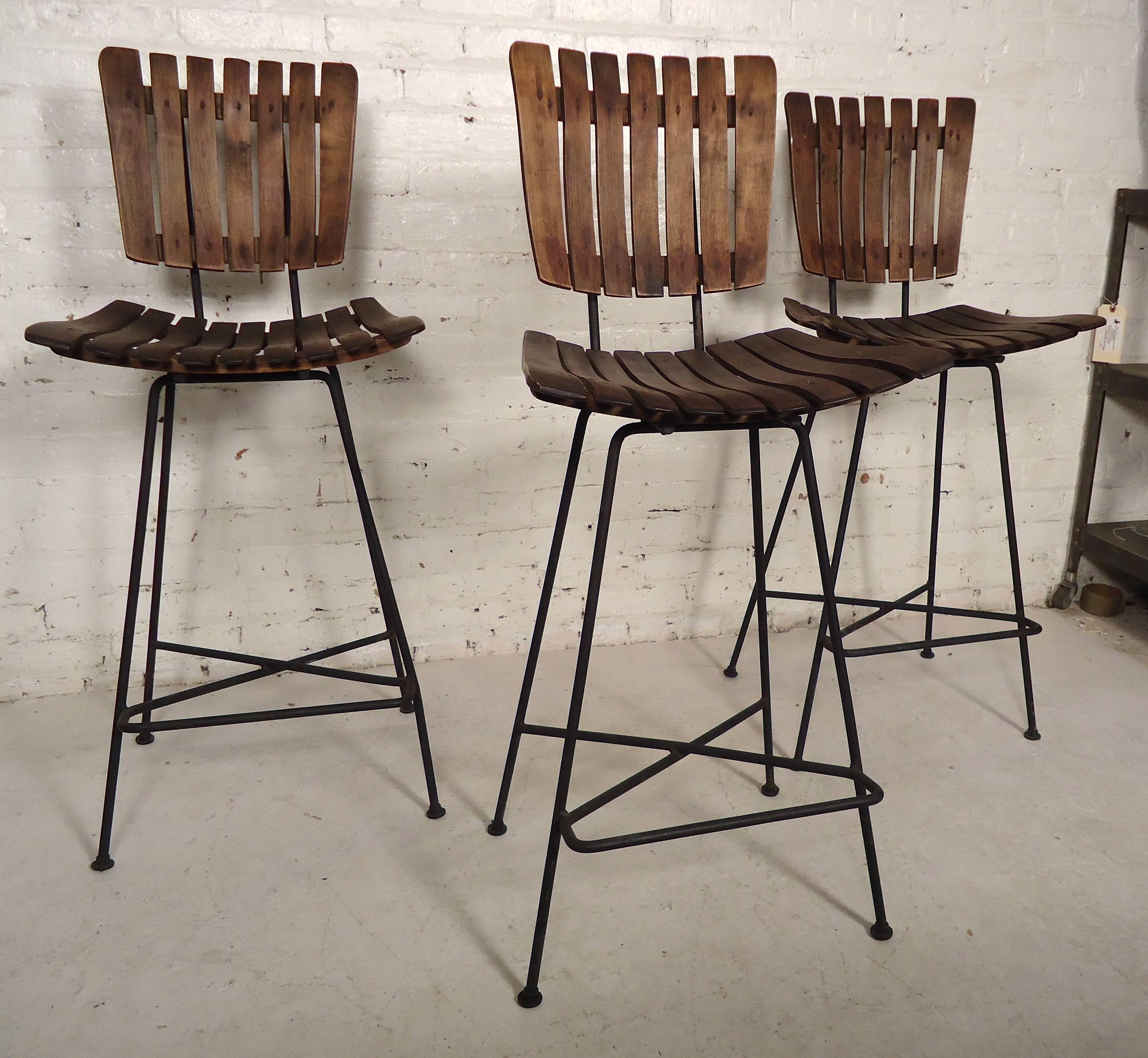 Set of three vintage modern counter height stools by Arthur Umanoff. Features his Classic slat wood design on a strong black iron frame.

(Please confirm item location NY or NJ with dealer).

 