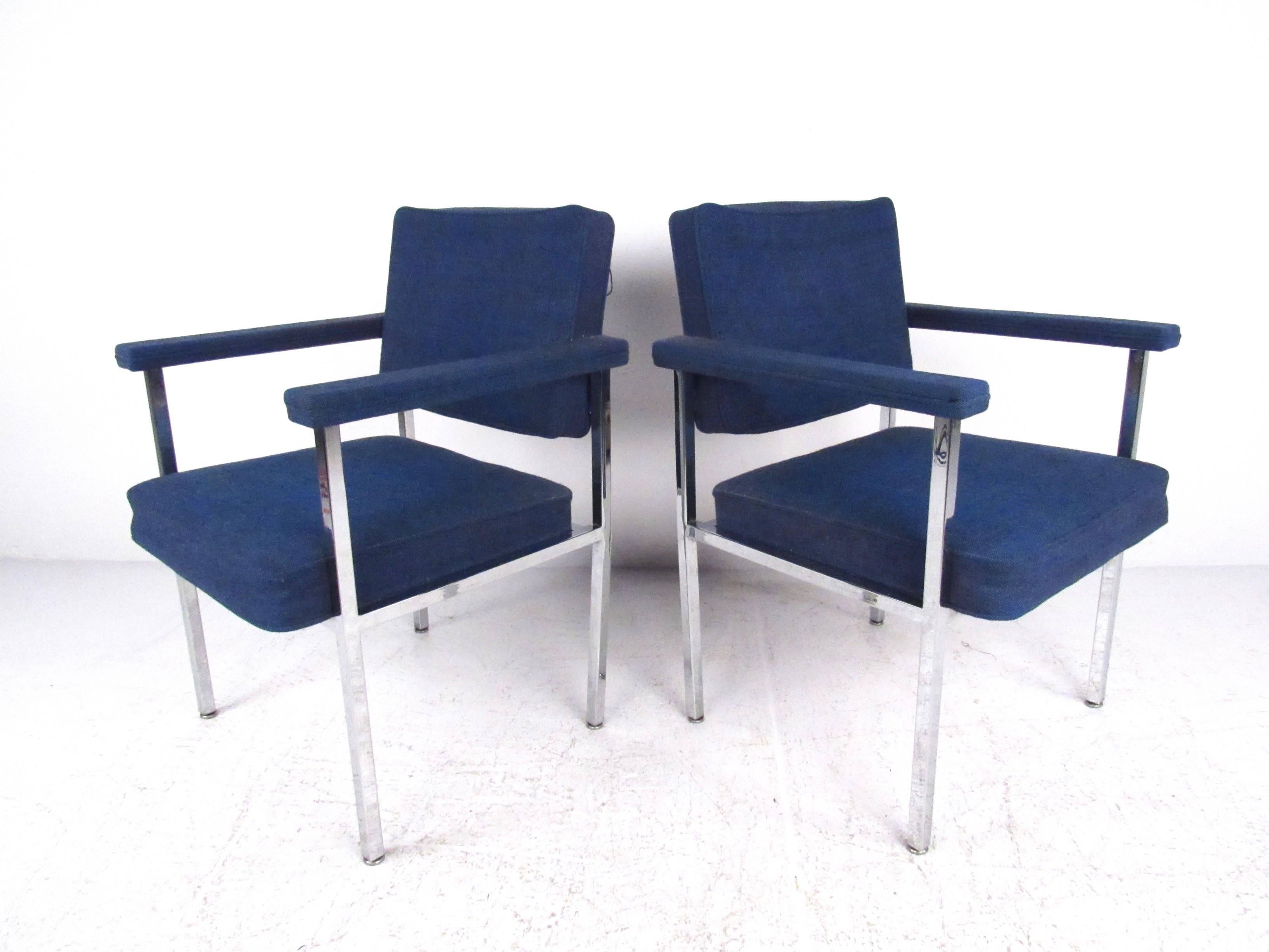 This stylish pair of Mid-Century armchairs make a comfortable vintage addition to any setting. With comfortably padded seats and sturdy chrome frames set this matching pair apart from other modern seating options. Please confirm item location (NY or